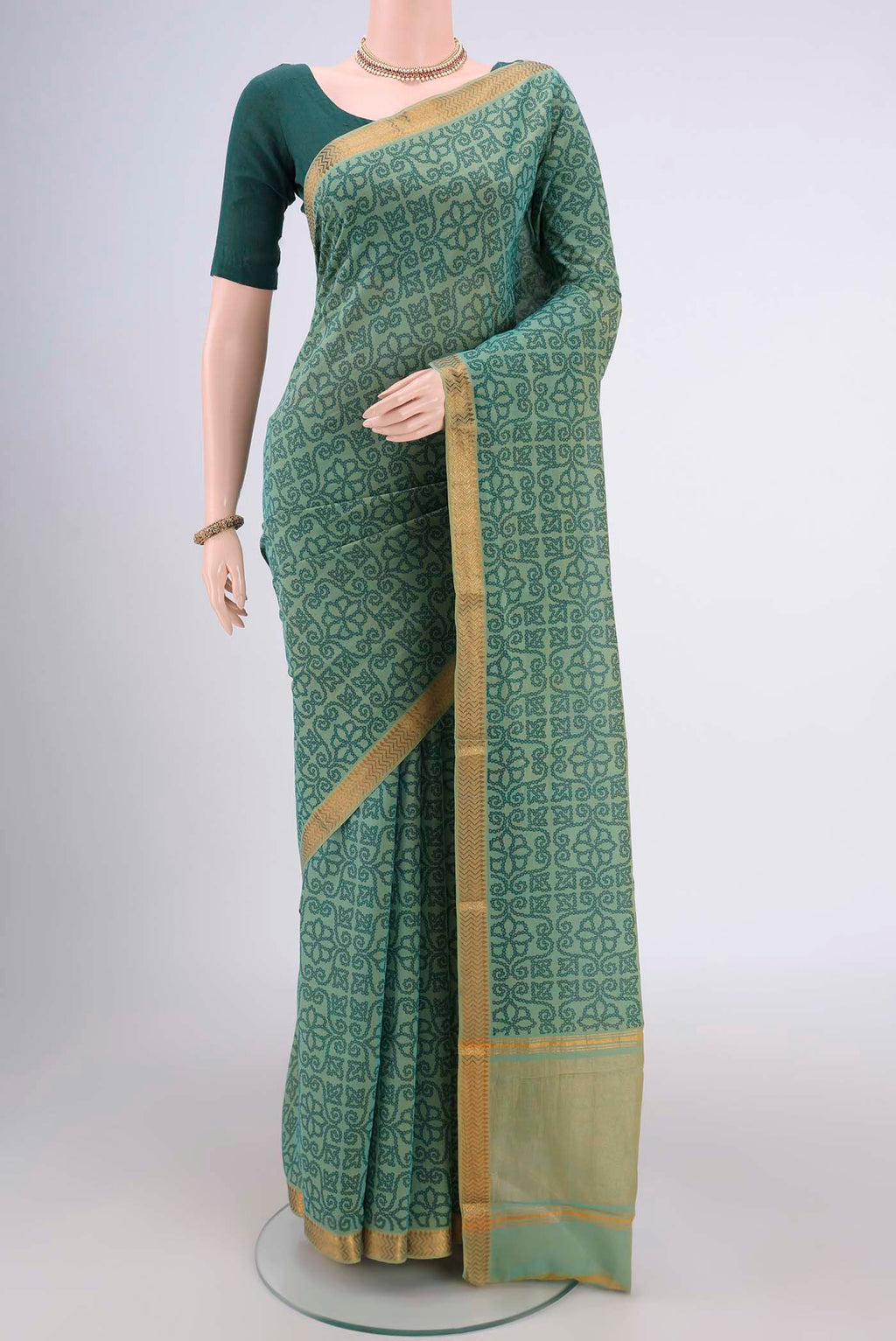 Light Green Mangalagiri Cotton Saree with Printed design on the body and Zari Border.  displayed on a mannequin