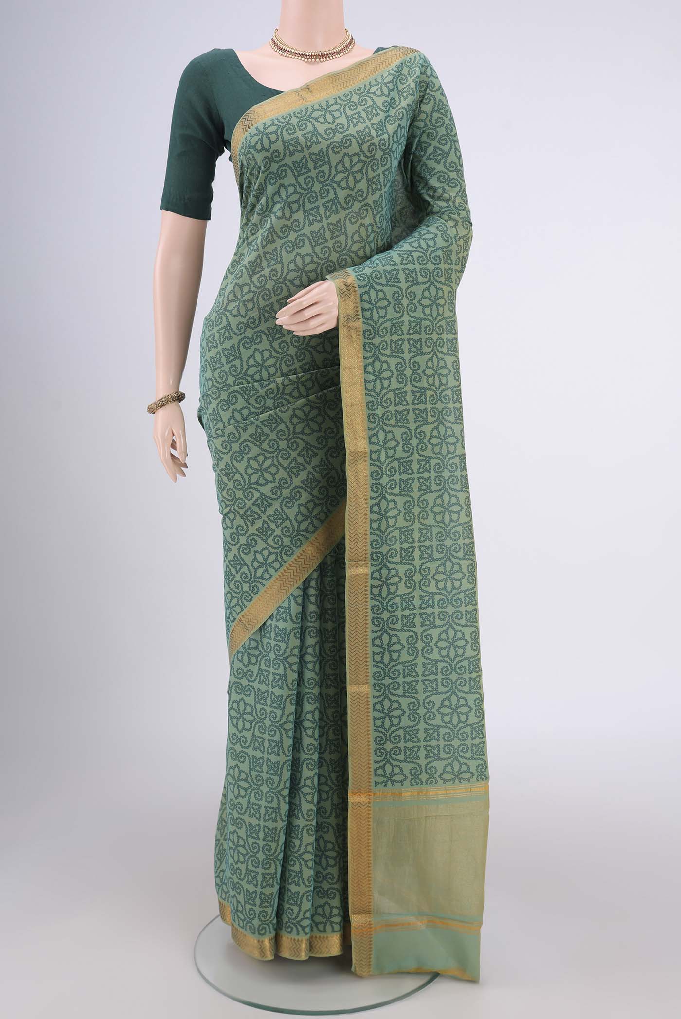 Light Green Mangalagiri Cotton Saree with Printed design on the body and Zari Border.  displayed on a mannequin