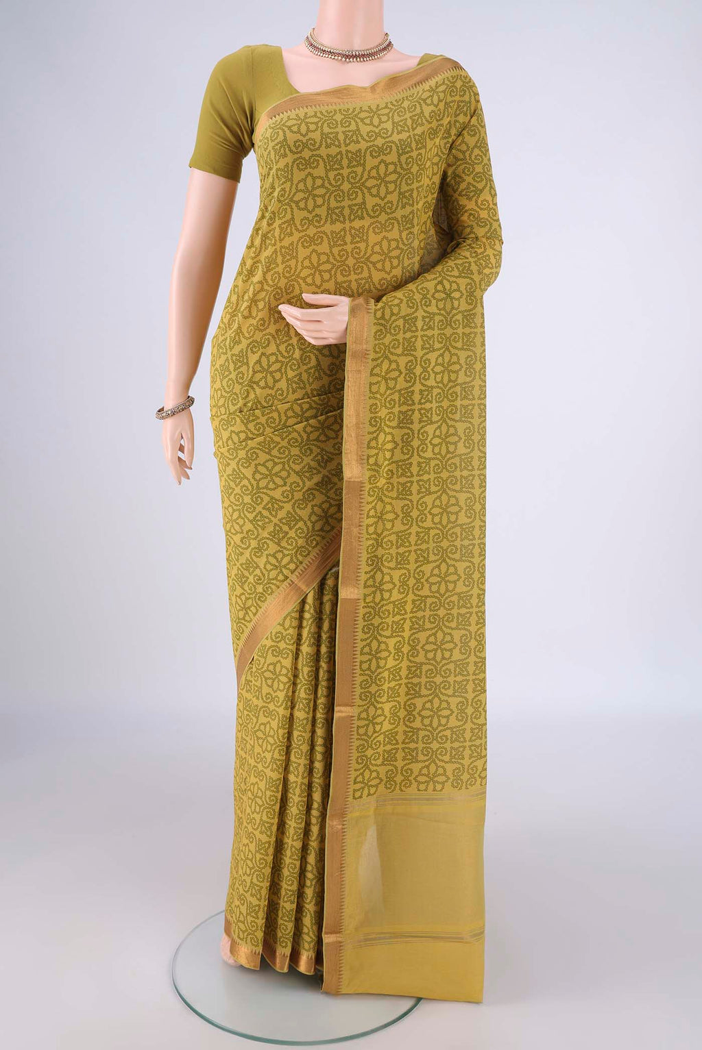 Mehandi Green Mangalagiri Cotton Saree with Printed design on the body and Zari Border.  displayed on a mannequin