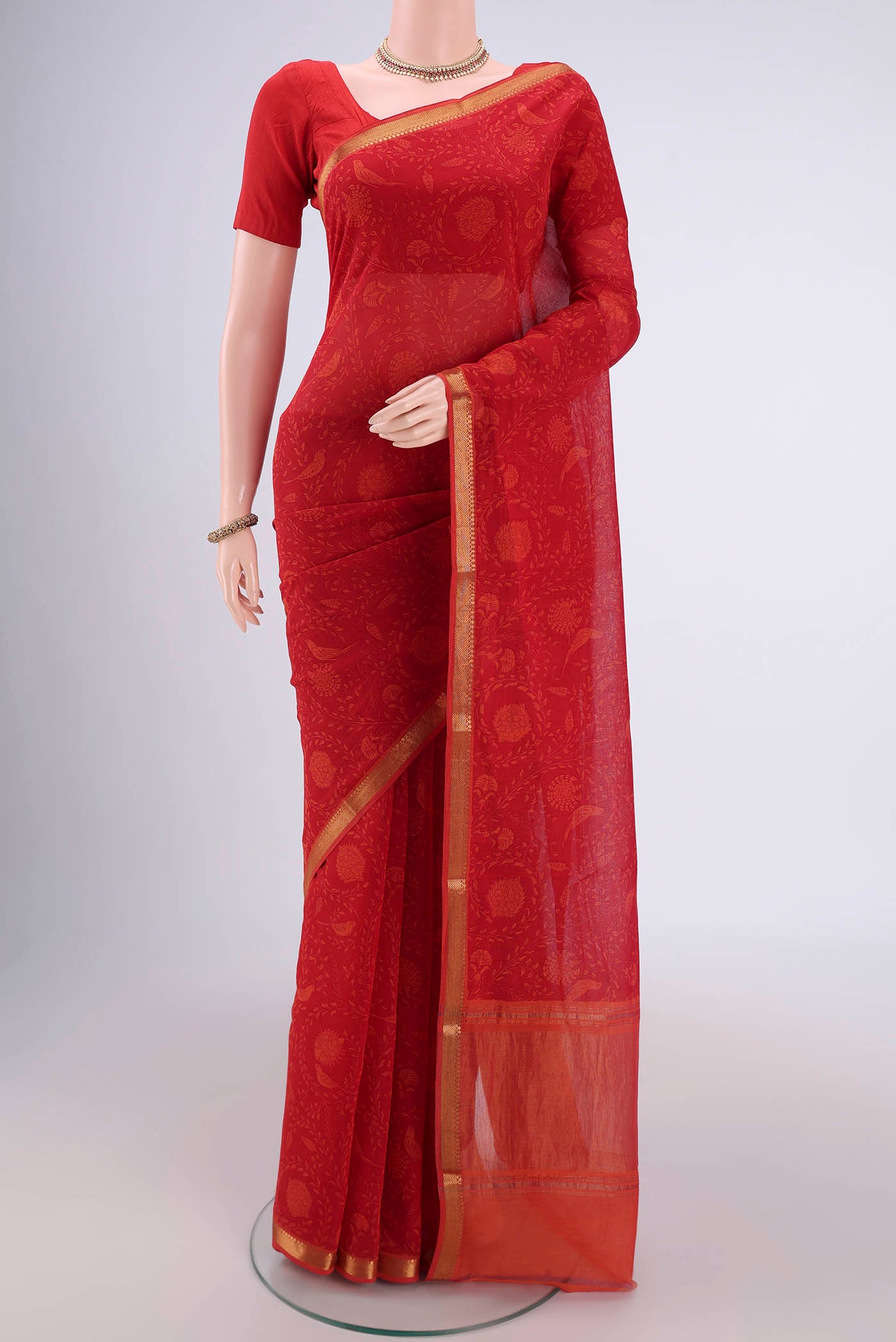 Red Mangalagiri Cotton Saree with Printed design on the body and Zari Border.  displayed on a mannequin