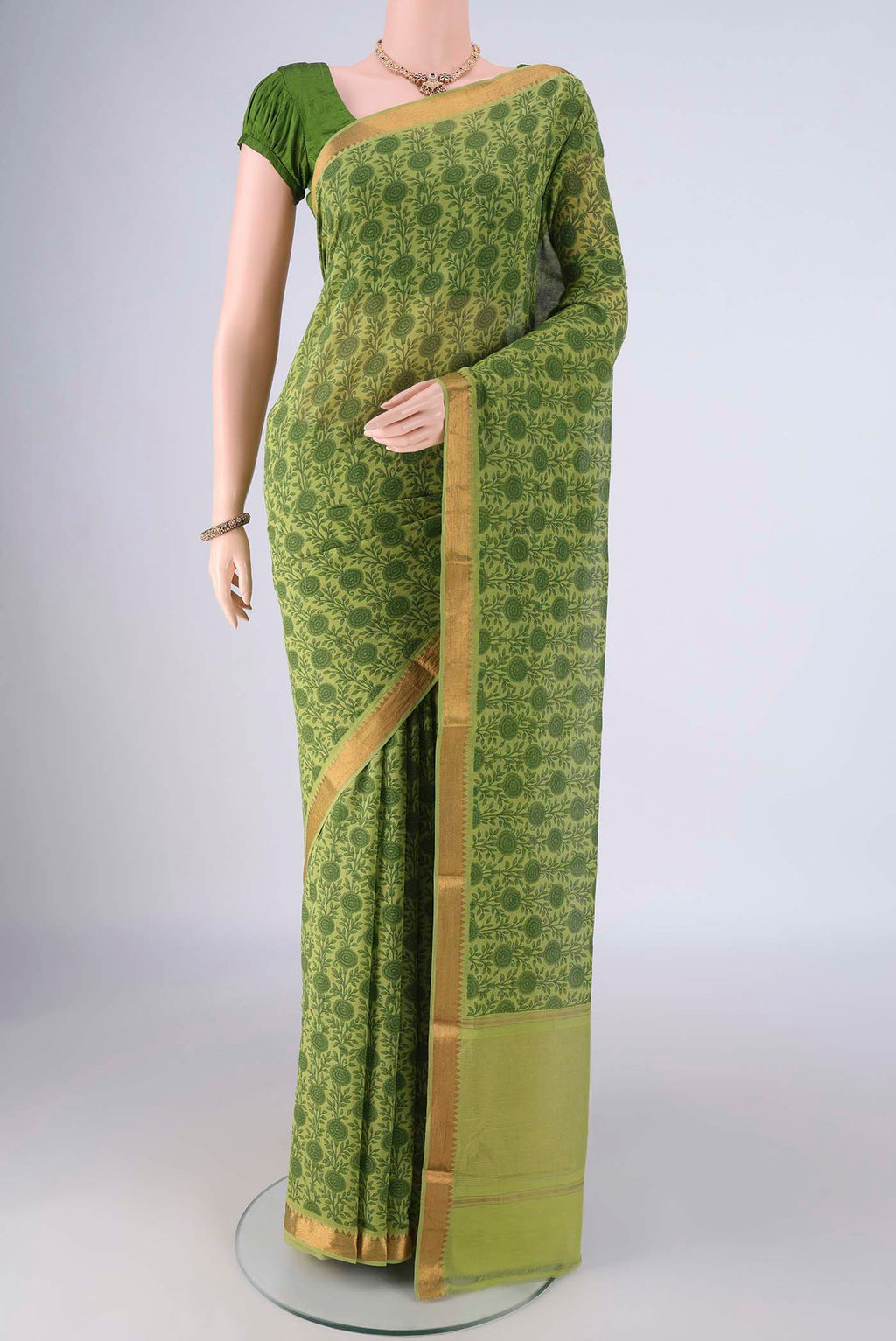 Green Mangalagiri Cotton Saree with Printed design on the body and Zari Border.  displayed on a mannequin