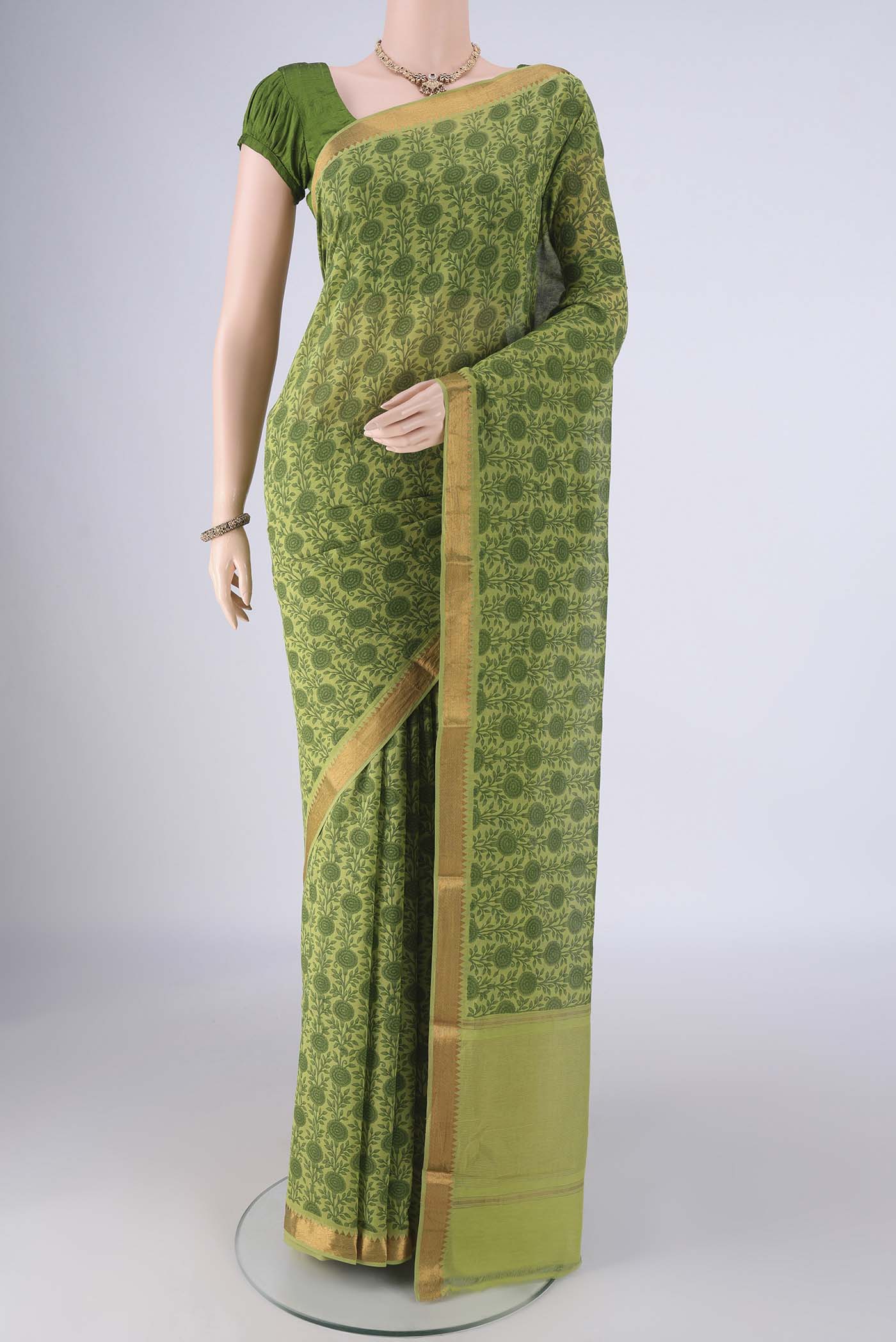 Green Mangalagiri Cotton Saree with Printed design on the body and Zari Border.  displayed on a mannequin