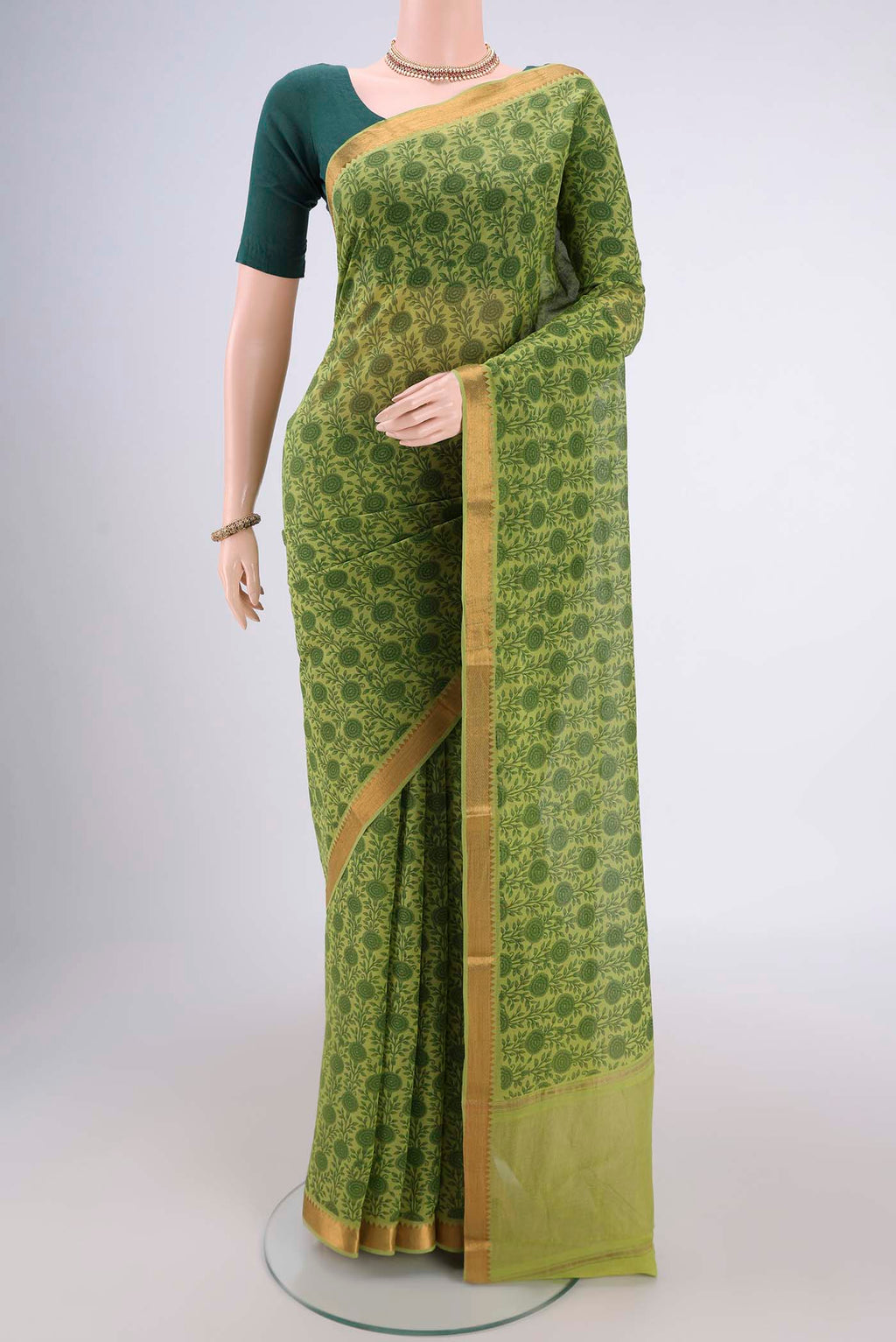 Green Mangalagiri Cotton Saree with Printed design on the body and Zari Border.  displayed on a mannequin