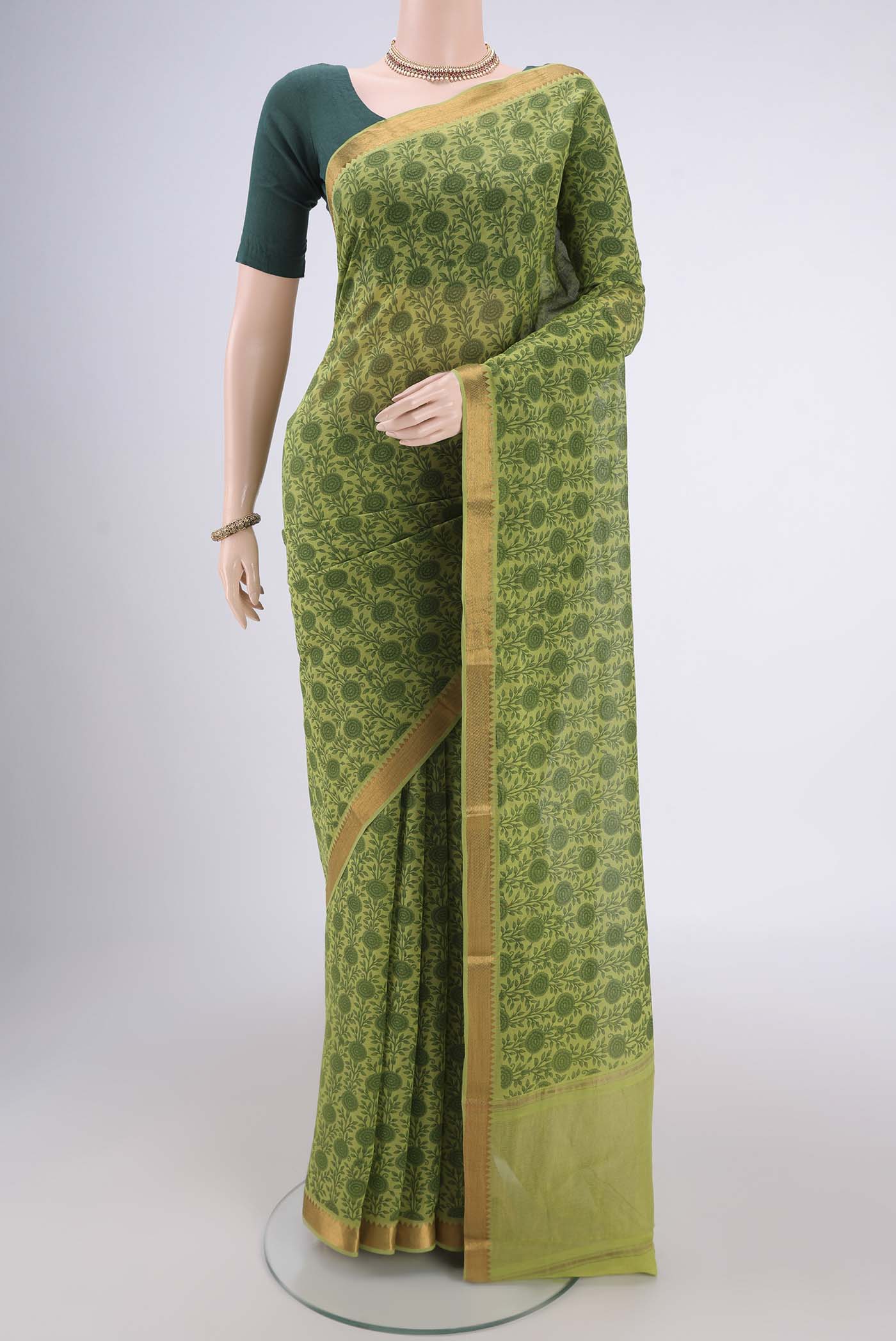Green Mangalagiri Cotton Saree with Printed design on the body and Zari Border.  displayed on a mannequin
