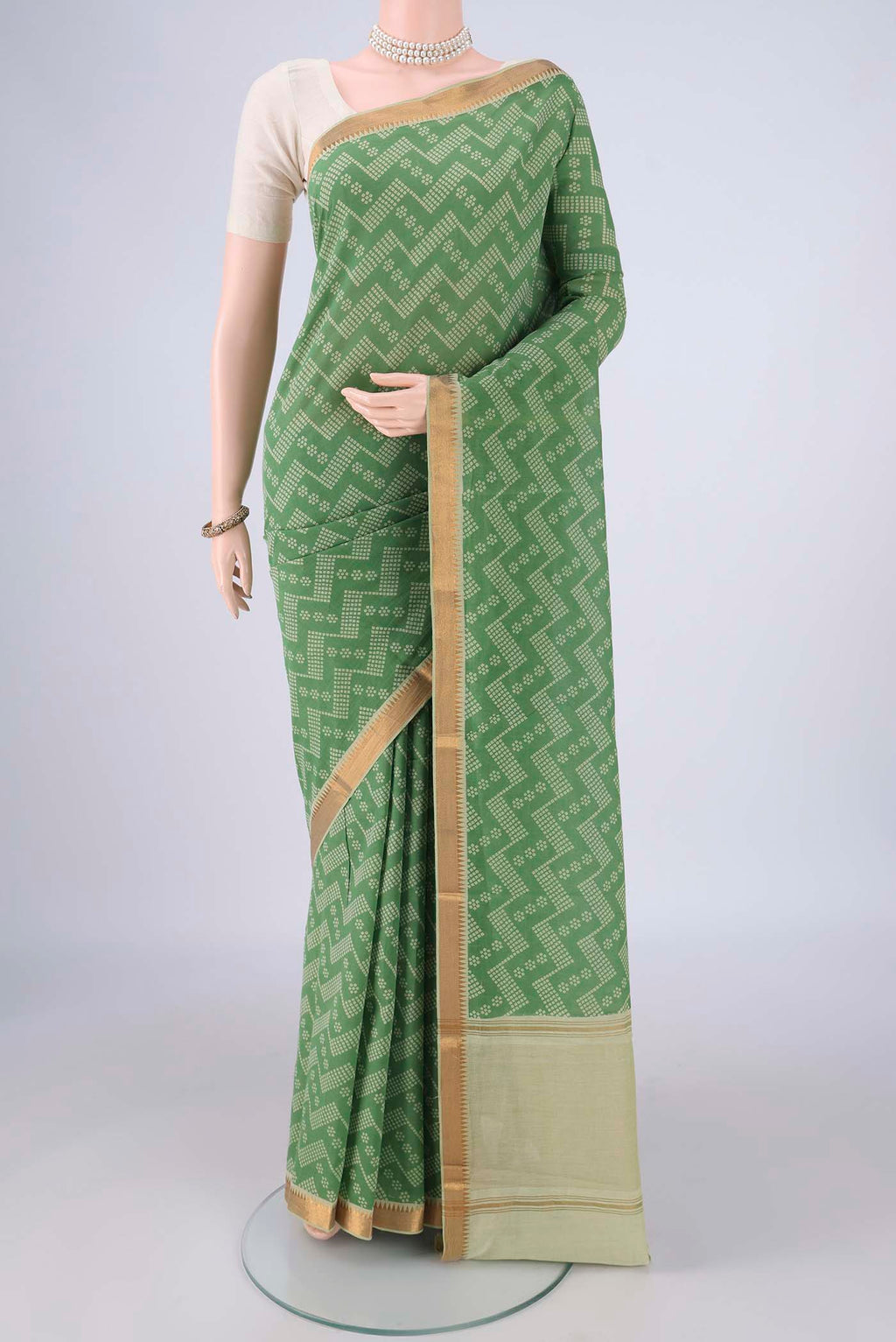 Olive Green Mangalagiri Cotton Saree with Printed design on the body and Zari Border.  displayed on a mannequin