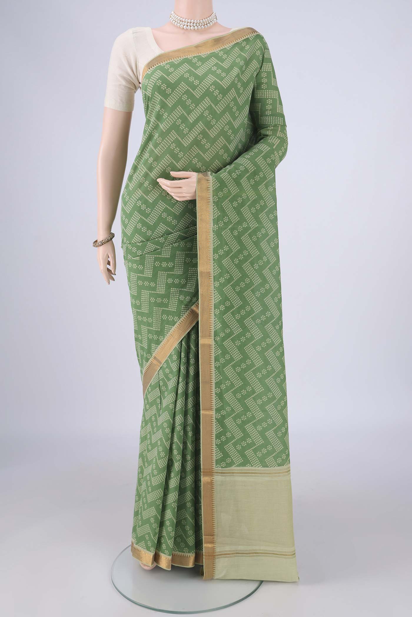 Olive Green Mangalagiri Cotton Saree with Printed design on the body and Zari Border.  displayed on a mannequin