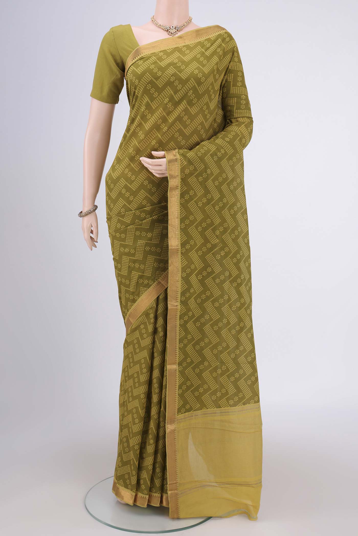 Mehandi Green Mangalagiri Cotton Saree with Printed design on the body and Zari Border.  displayed on a mannequin