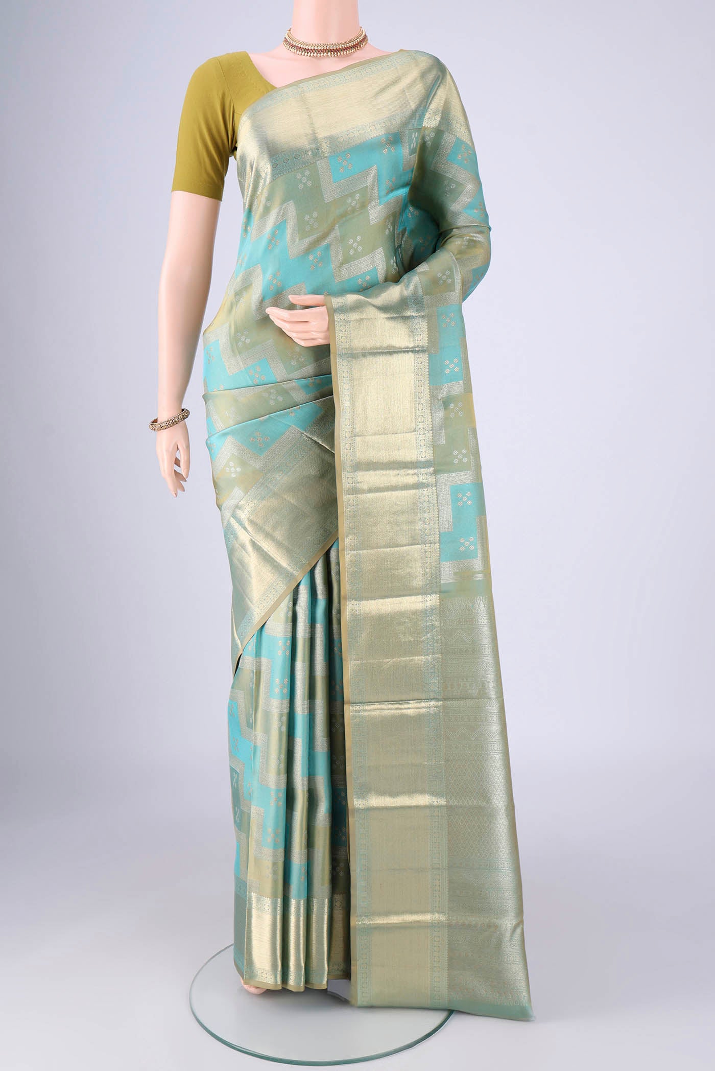 Turquoise Kanjivaram Silk Saree with Zari Brocade on the body and Zari Border.  displayed on a mannequin