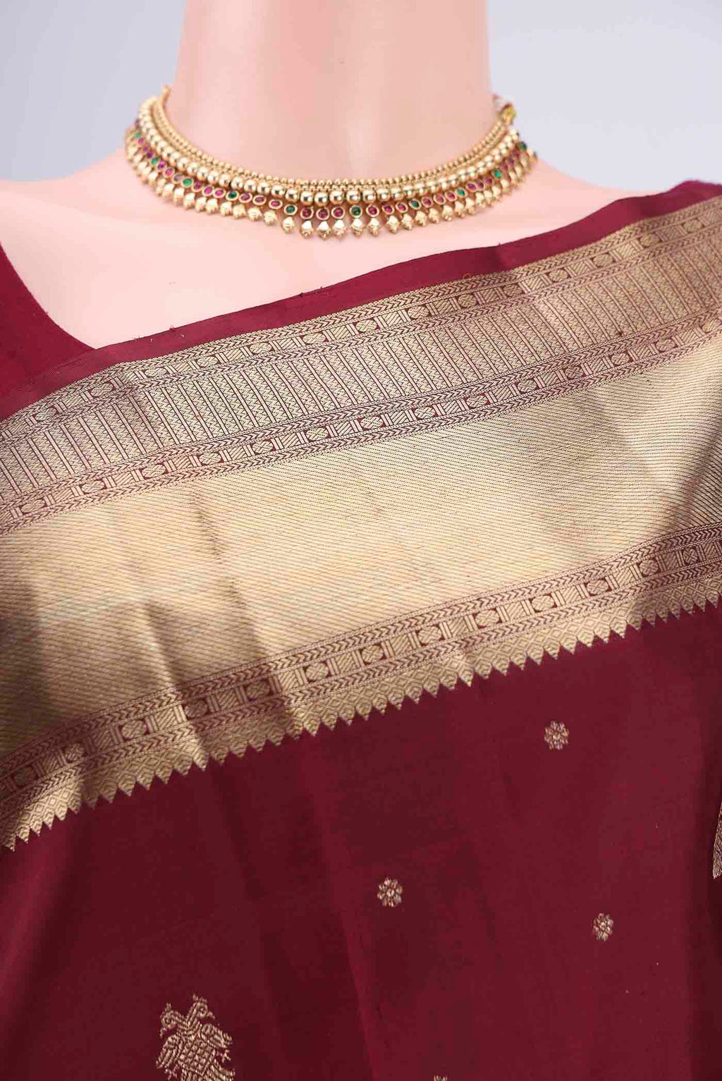 Border image of Maroon Kanjivaram Silk Saree with Zari Butta on the body and Zari Border. 