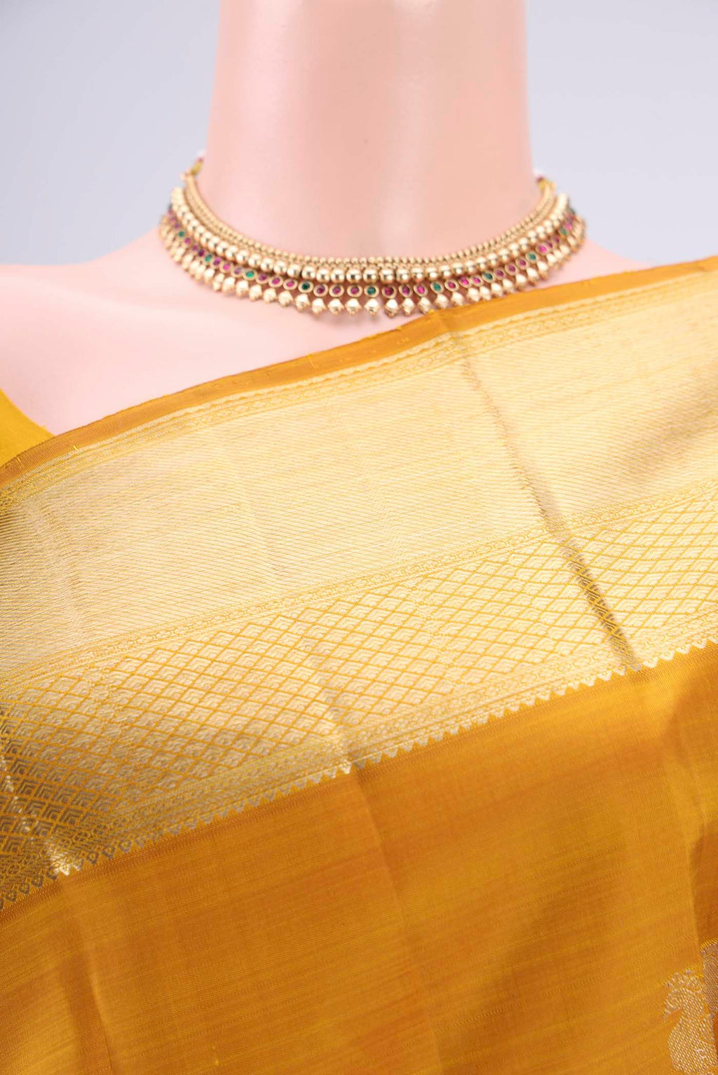 Border image of Mustard Kanjivaram Silk Saree with Zari Butta on the body and Zari Border. 