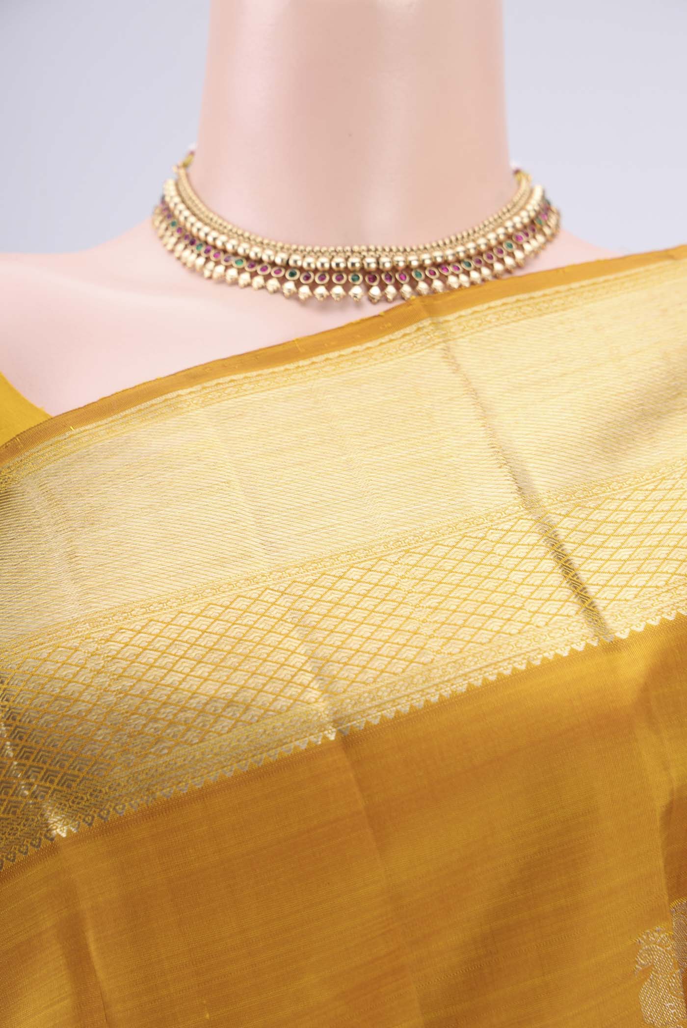 Border image of Mustard Kanjivaram Silk Saree with Zari Butta on the body and Zari Border. 