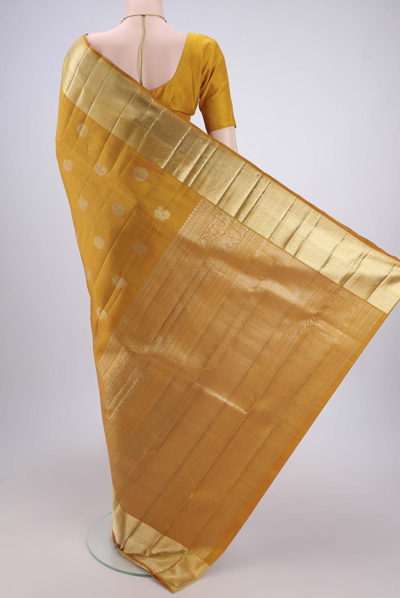 Flat view of Mustard Kanjivaram Silk Saree with Zari Butta on the body and Zari Border. 