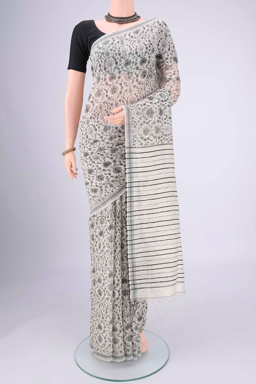 Off White Tussar Silk Saree with Printed design on the body and Plain Border.  displayed on a mannequin