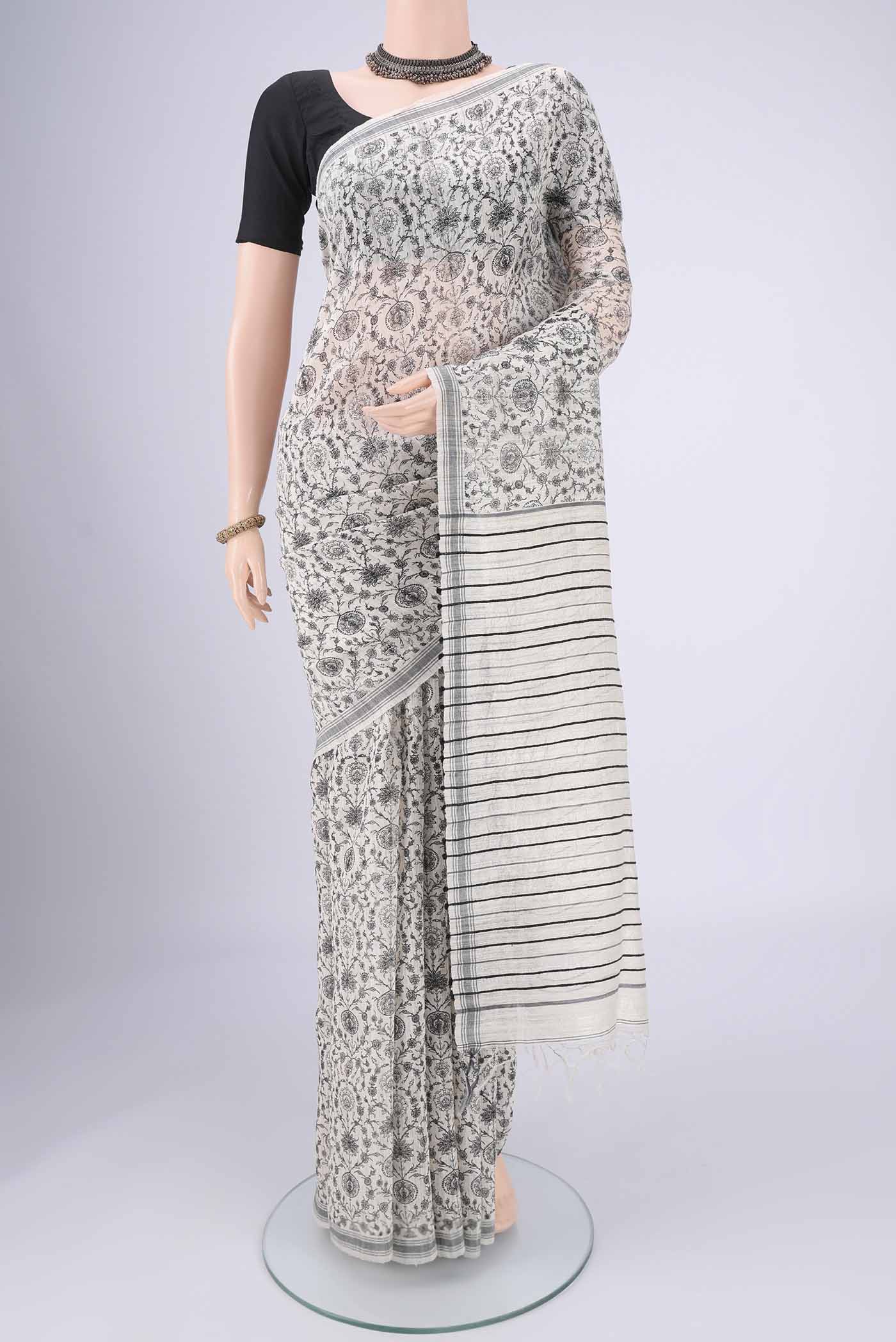 Off White Tussar Silk Saree with Printed design on the body and Plain Border.  displayed on a mannequin