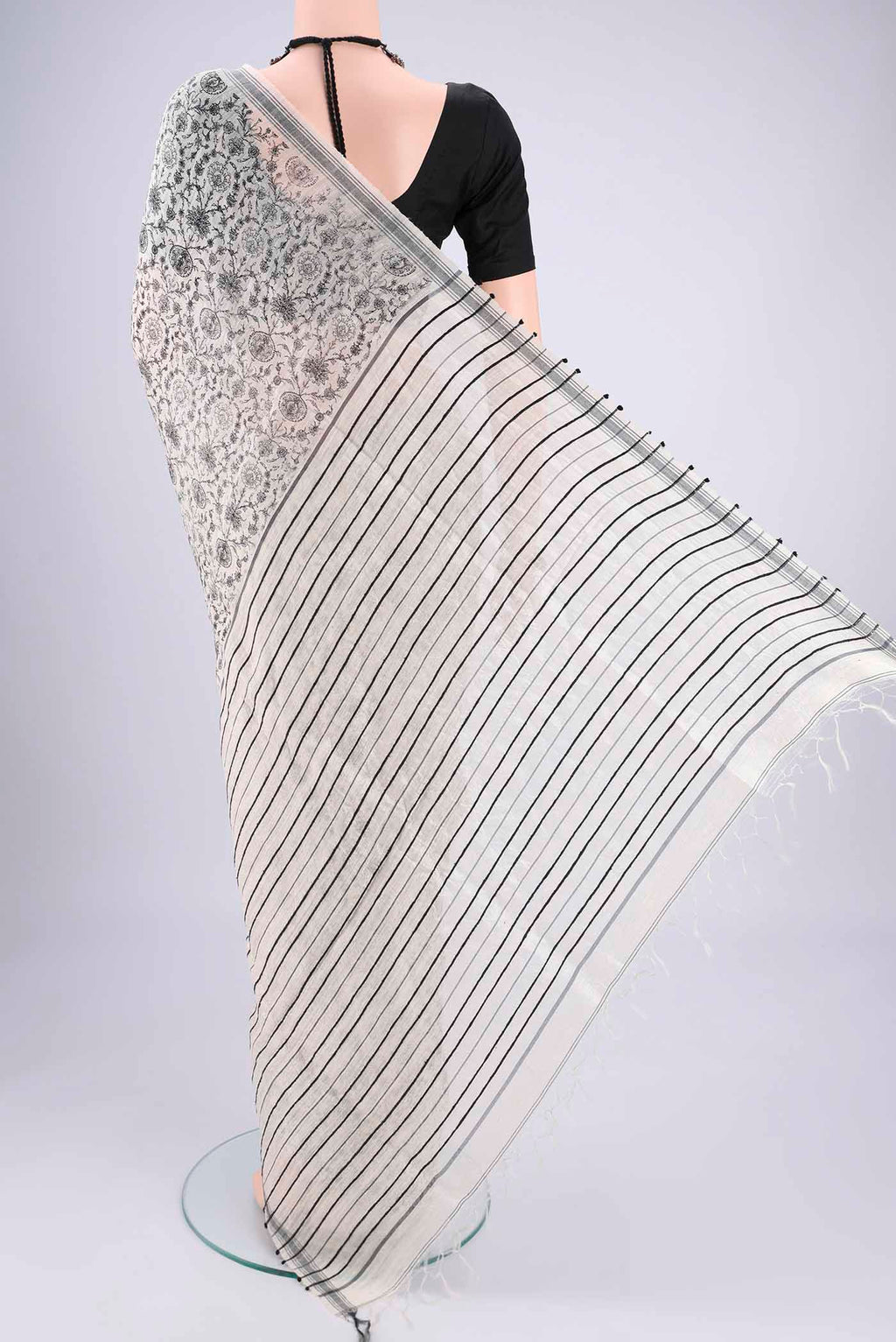 Flat view of Off White Tussar Silk Saree with Printed design on the body and Plain Border. 