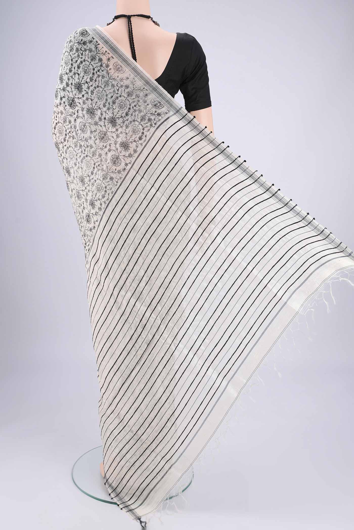 Flat view of Off White Tussar Silk Saree with Printed design on the body and Plain Border. 