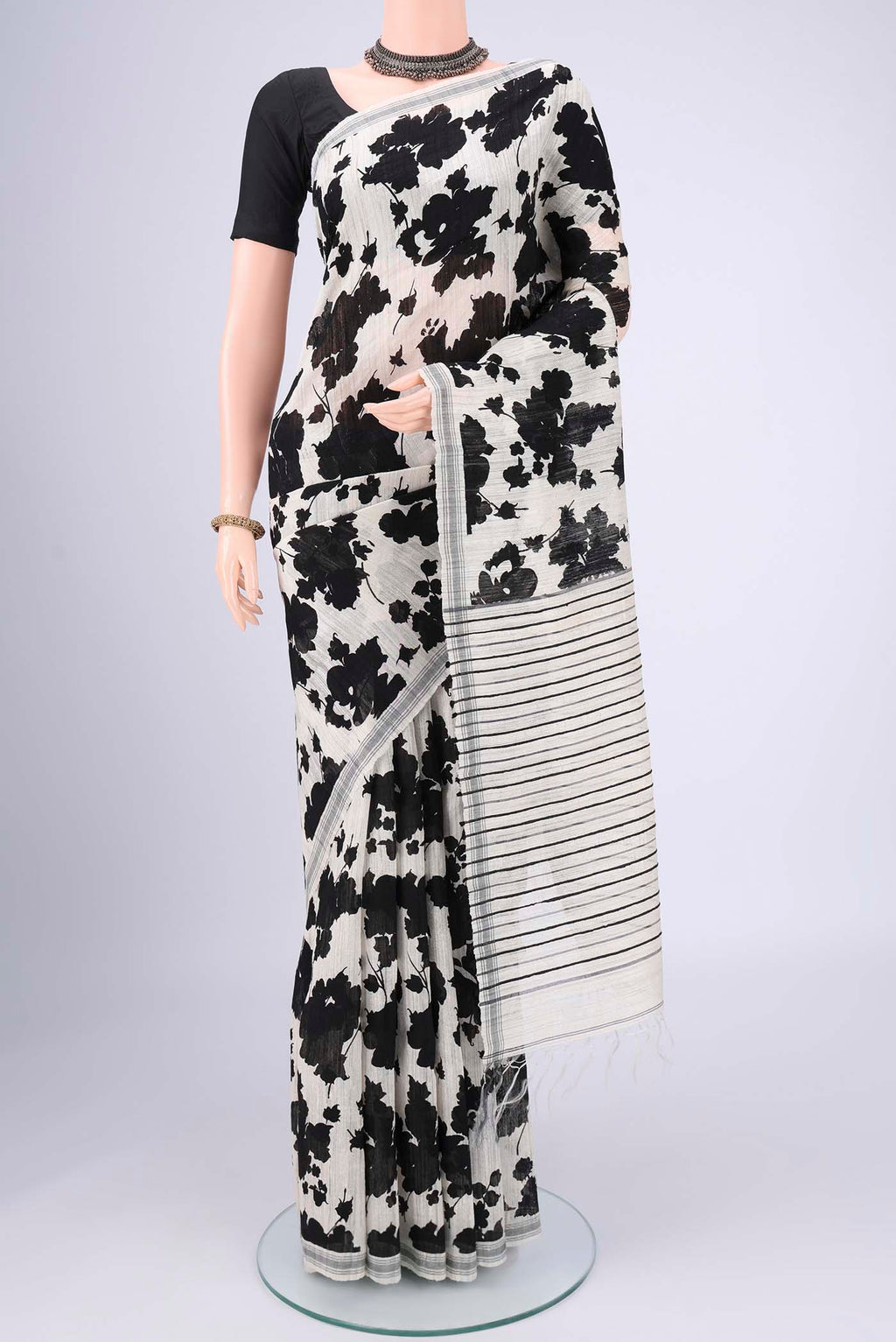 Off White Tussar Silk Saree with Floral Print on the body and Plain Border.  displayed on a mannequin