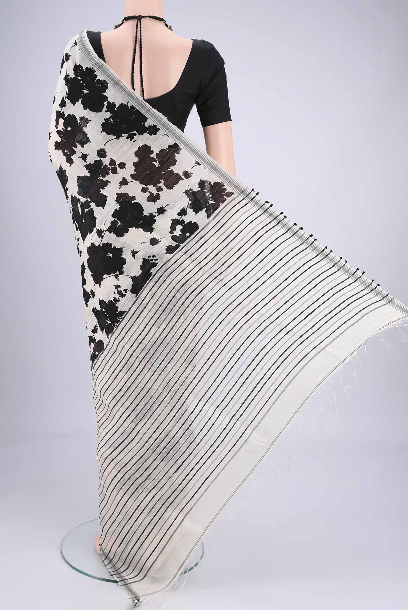 Flat view of Off White Tussar Silk Saree with Floral Print on the body and Plain Border. 