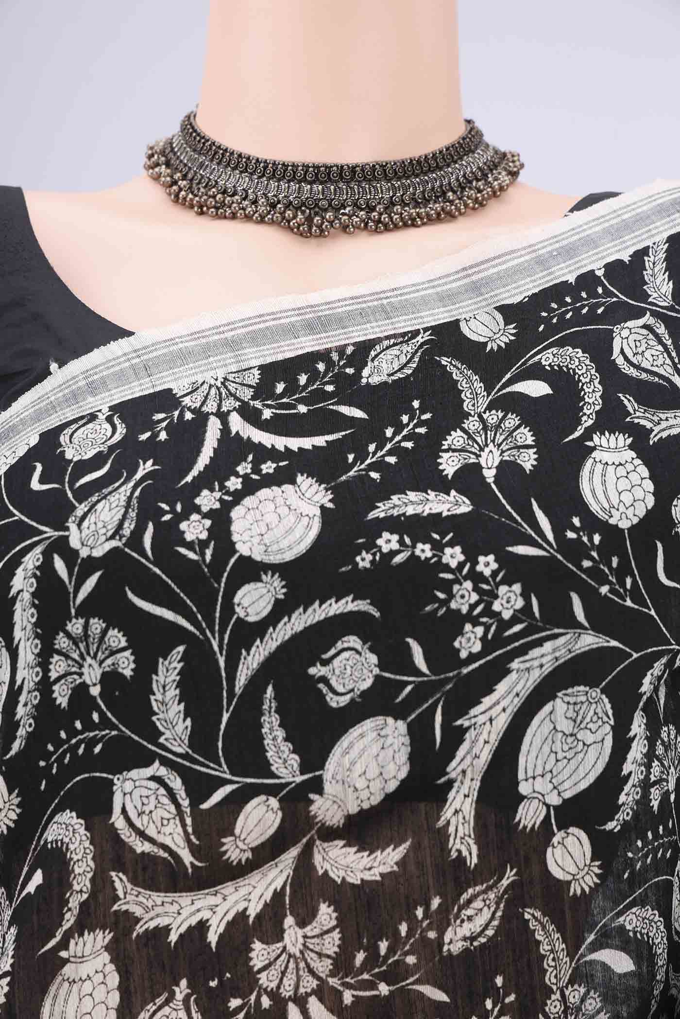 Border image of Black Tussar Silk Saree with Printed design on the body and Plain Border. 