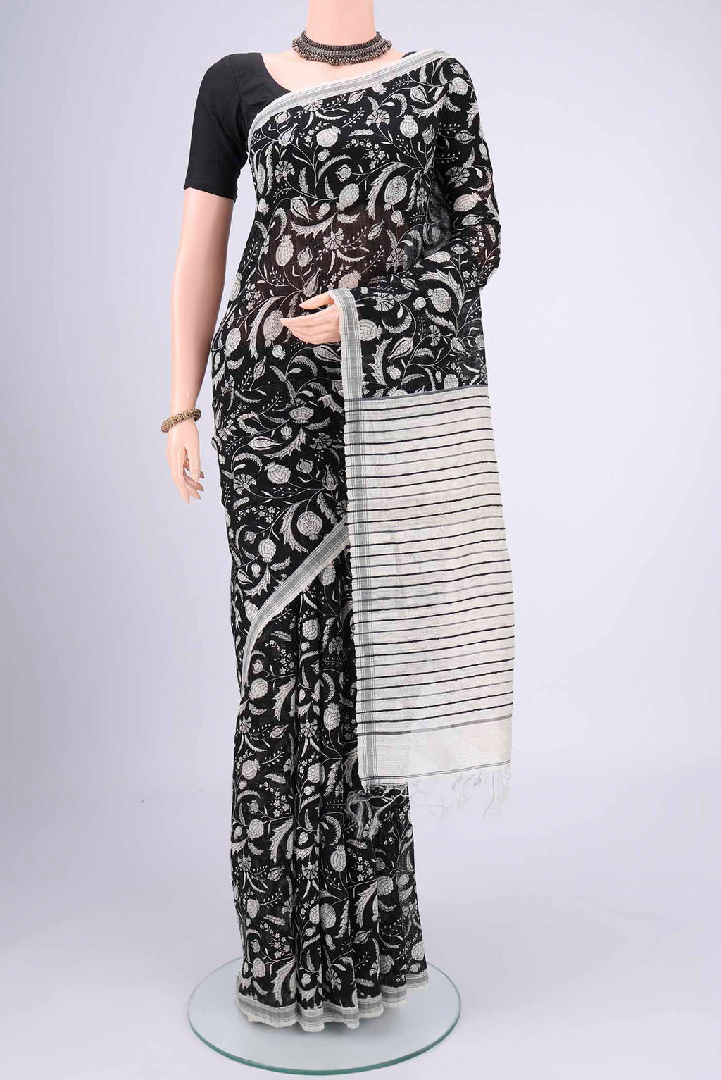 Black Tussar Silk Saree with Printed design on the body and Plain Border.  displayed on a mannequin