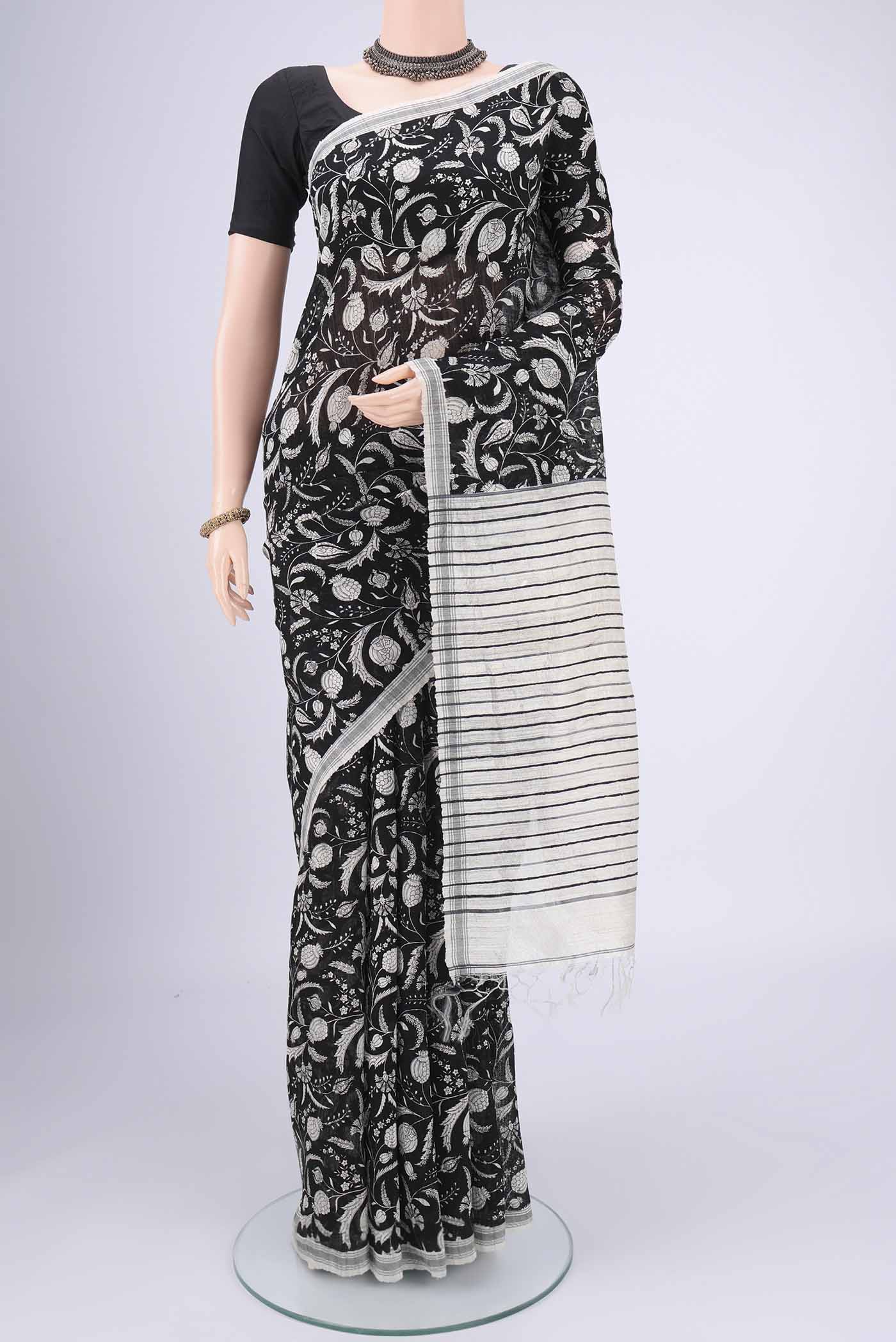 Black Tussar Silk Saree with Printed design on the body and Plain Border.  displayed on a mannequin