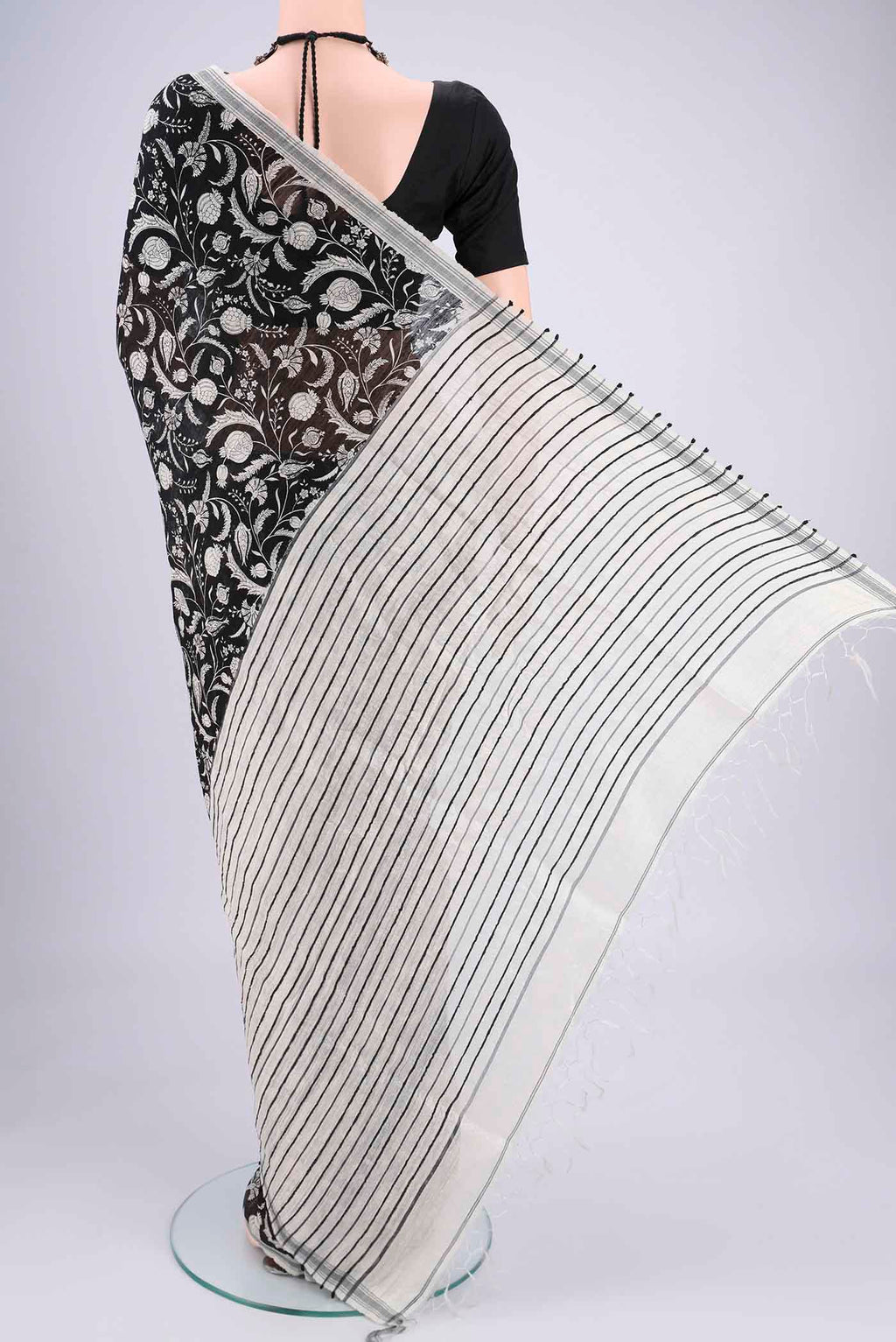 Flat view of Black Tussar Silk Saree with Printed design on the body and Plain Border. 
