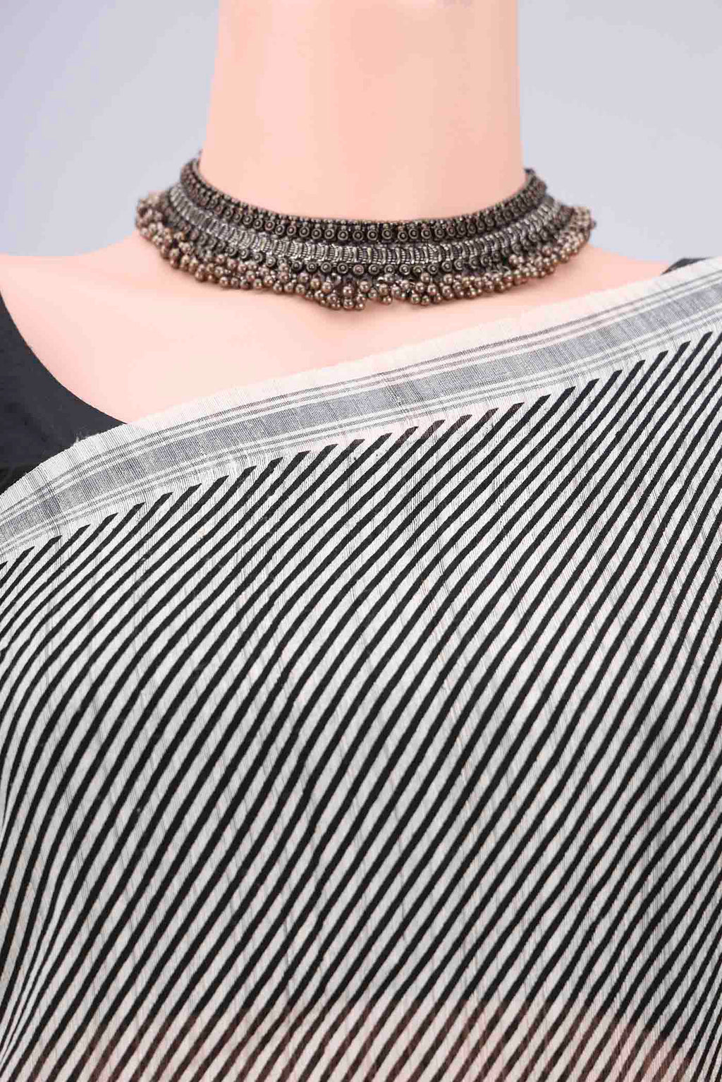 Border image of Off White Tussar Silk Saree with Stripes on the body and Plain Border. 