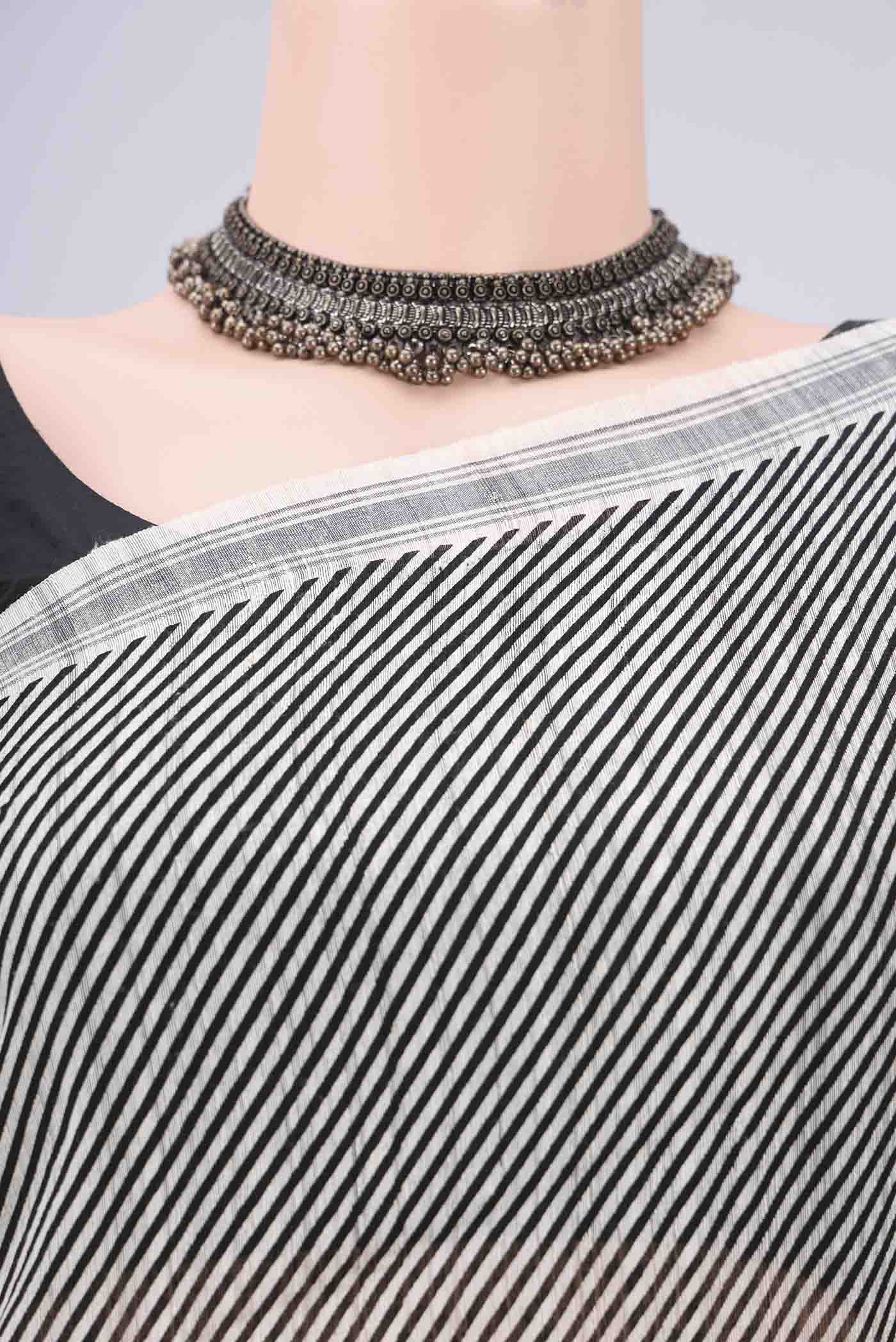 Border image of Off White Tussar Silk Saree with Stripes on the body and Plain Border. 