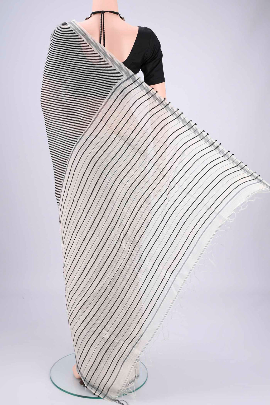 Flat view of Off White Tussar Silk Saree with Stripes on the body and Plain Border. 