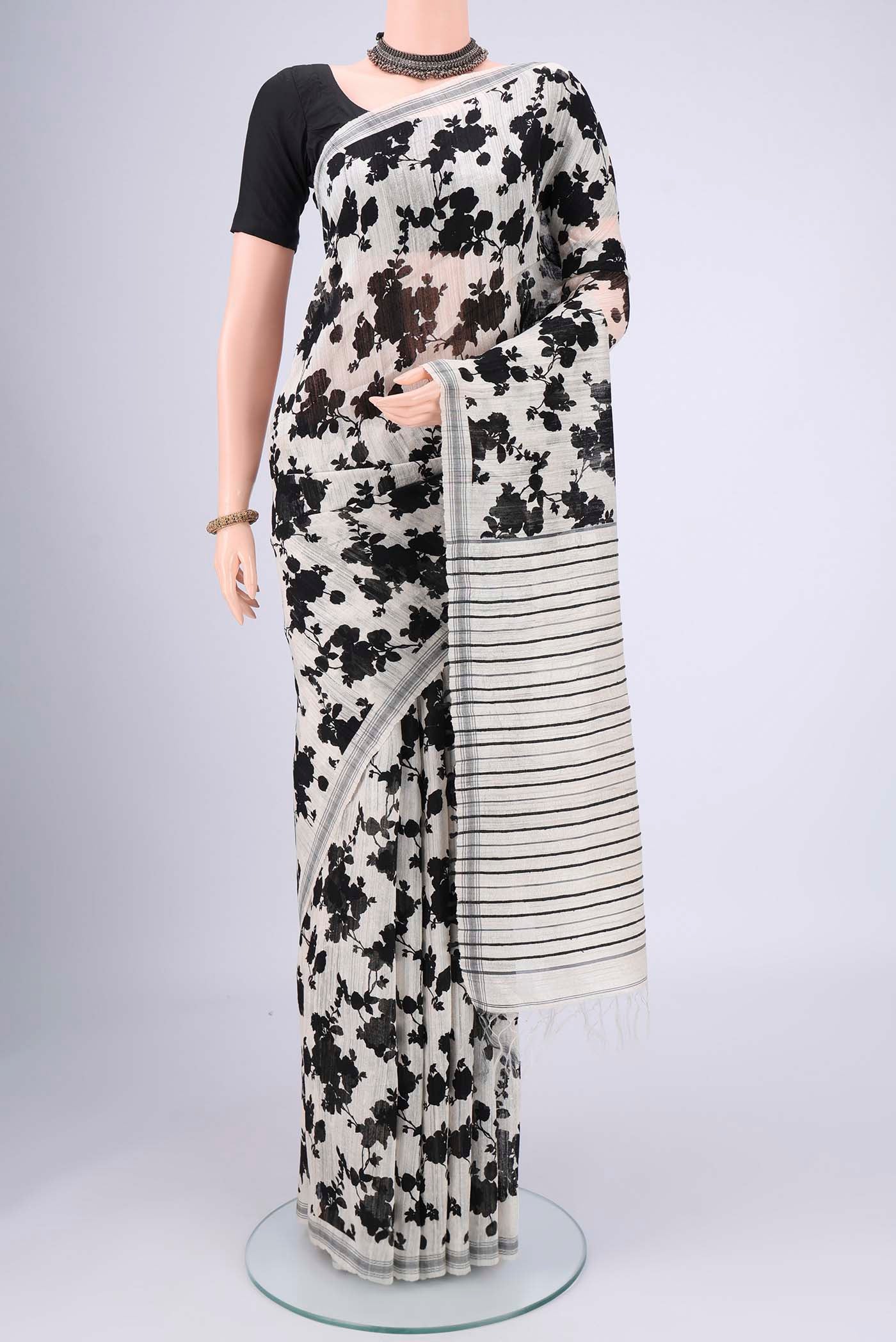 Off White Tussar Silk Saree with Floral Print on the body and Plain Border.  displayed on a mannequin