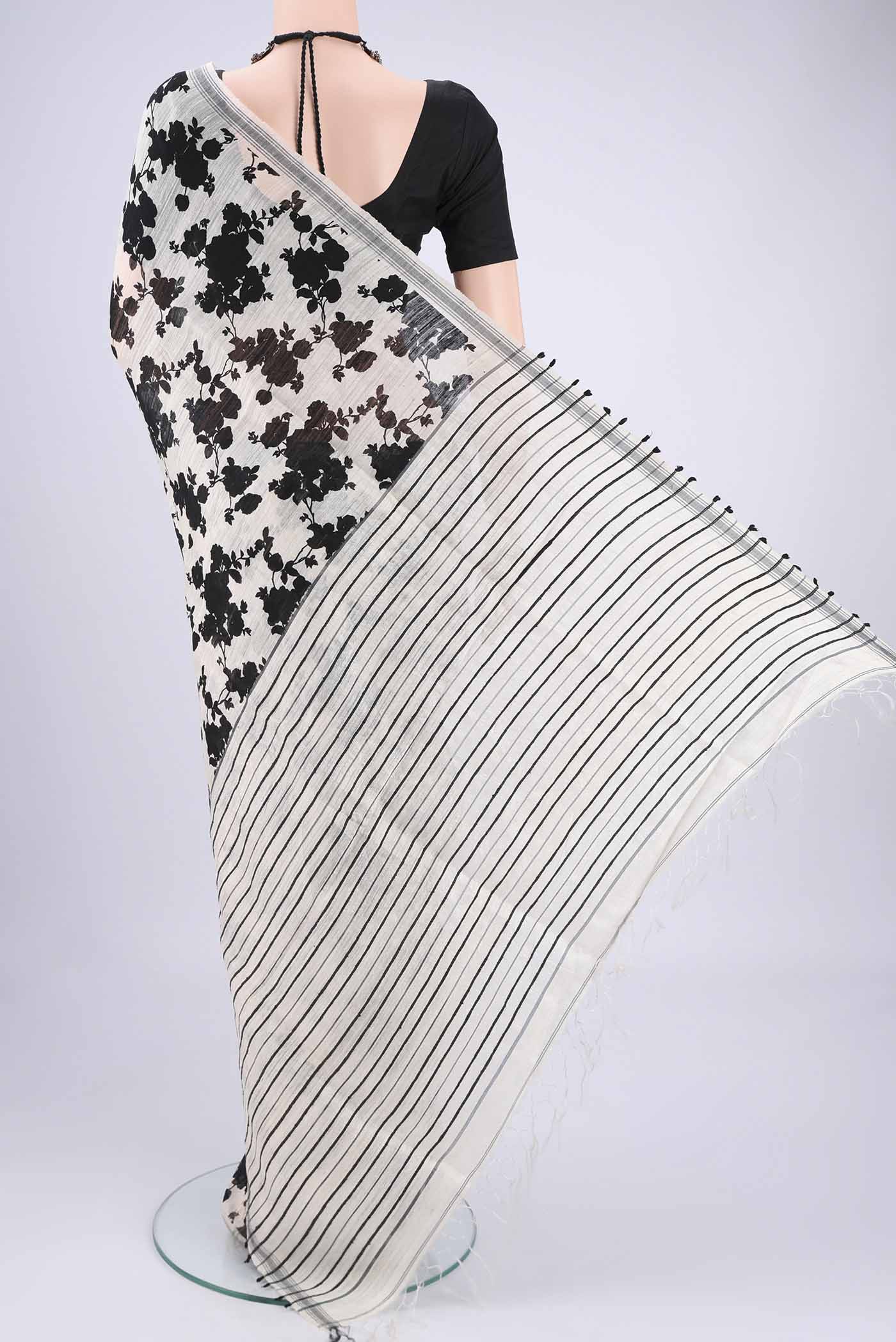 Flat view of Off White Tussar Silk Saree with Floral Print on the body and Plain Border. 