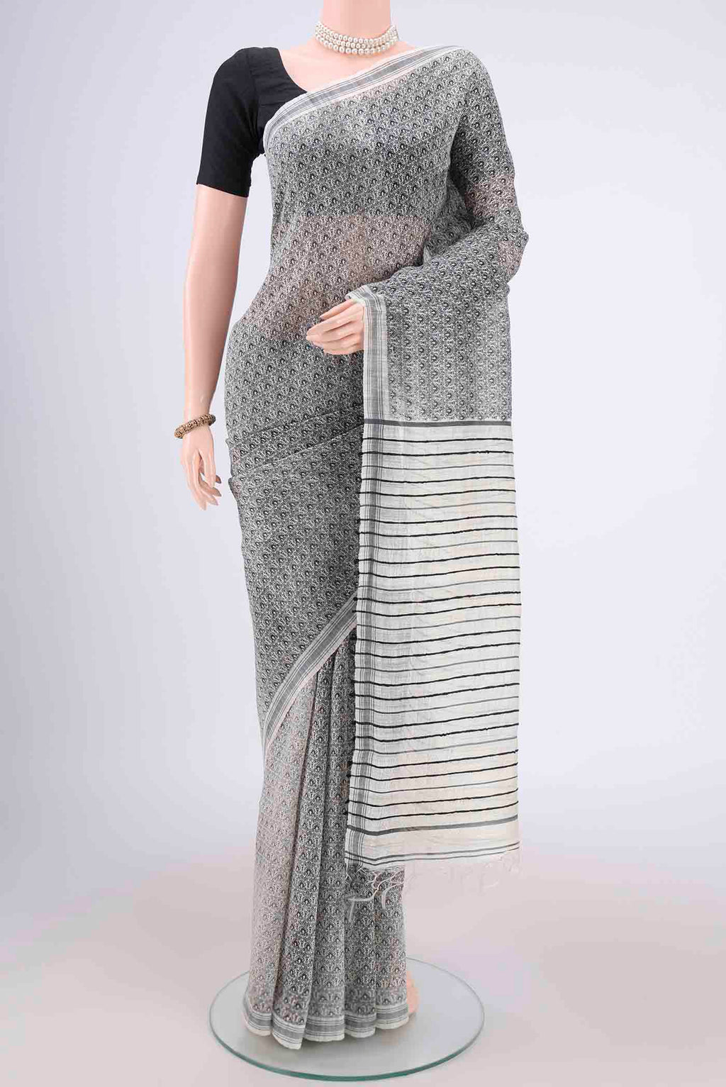 Off White Tussar Silk Saree with Printed design on the body and Plain Border.  displayed on a mannequin