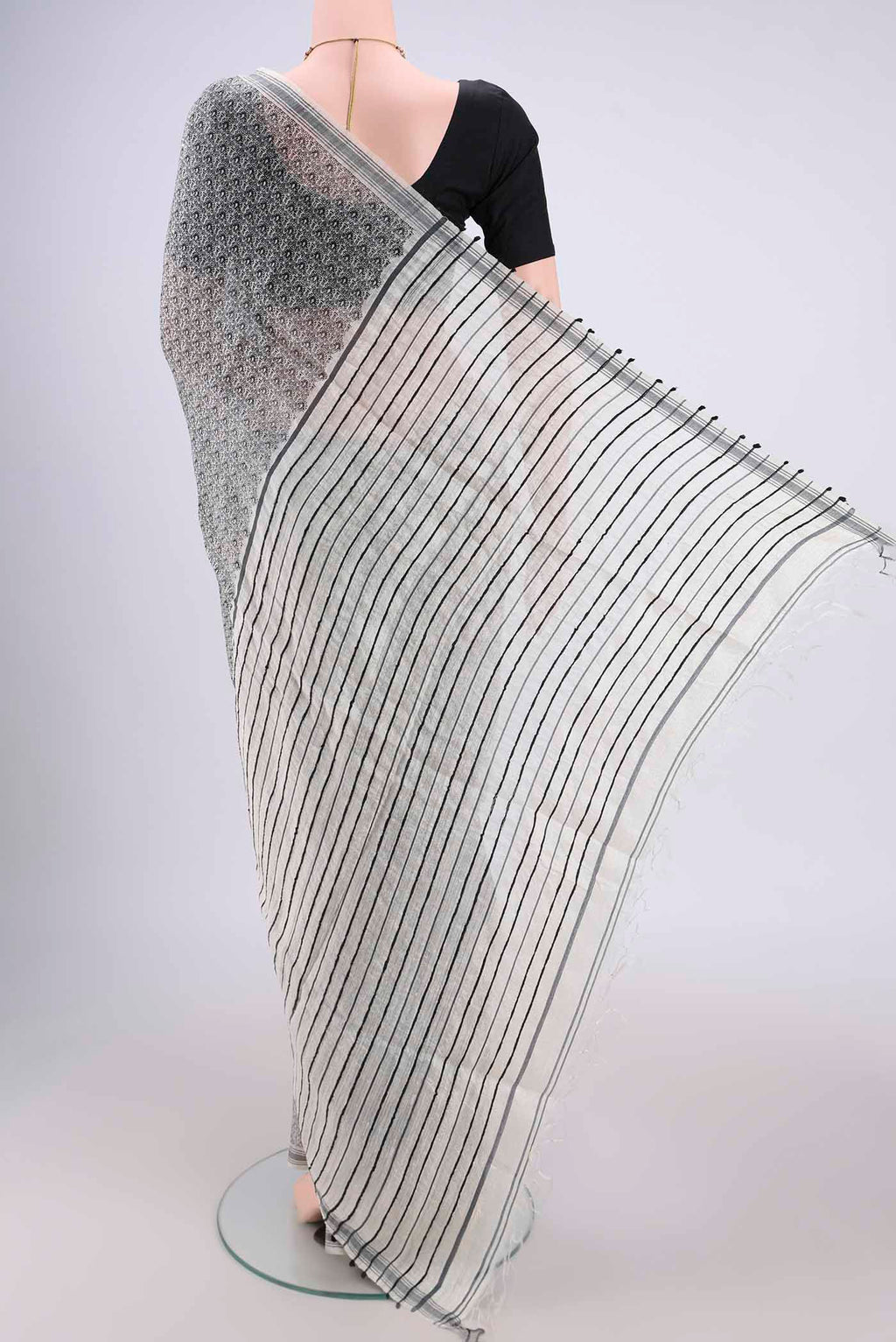 Flat view of Off White Tussar Silk Saree with Printed design on the body and Plain Border. 