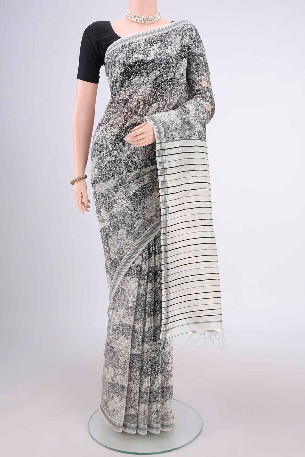 Off White Tussar Silk Saree with Printed design on the body and Plain Border.  displayed on a mannequin