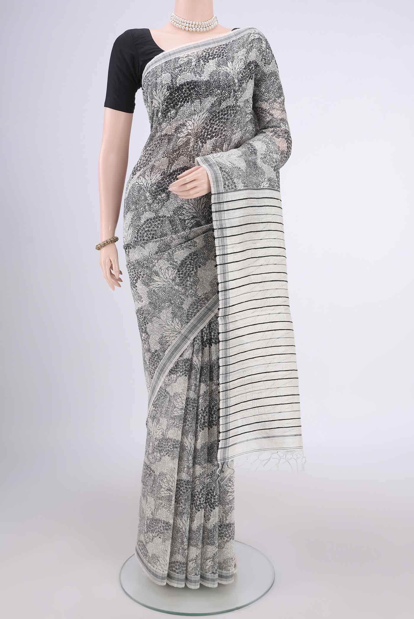 Off White Tussar Silk Saree with Printed design on the body and Plain Border.  displayed on a mannequin