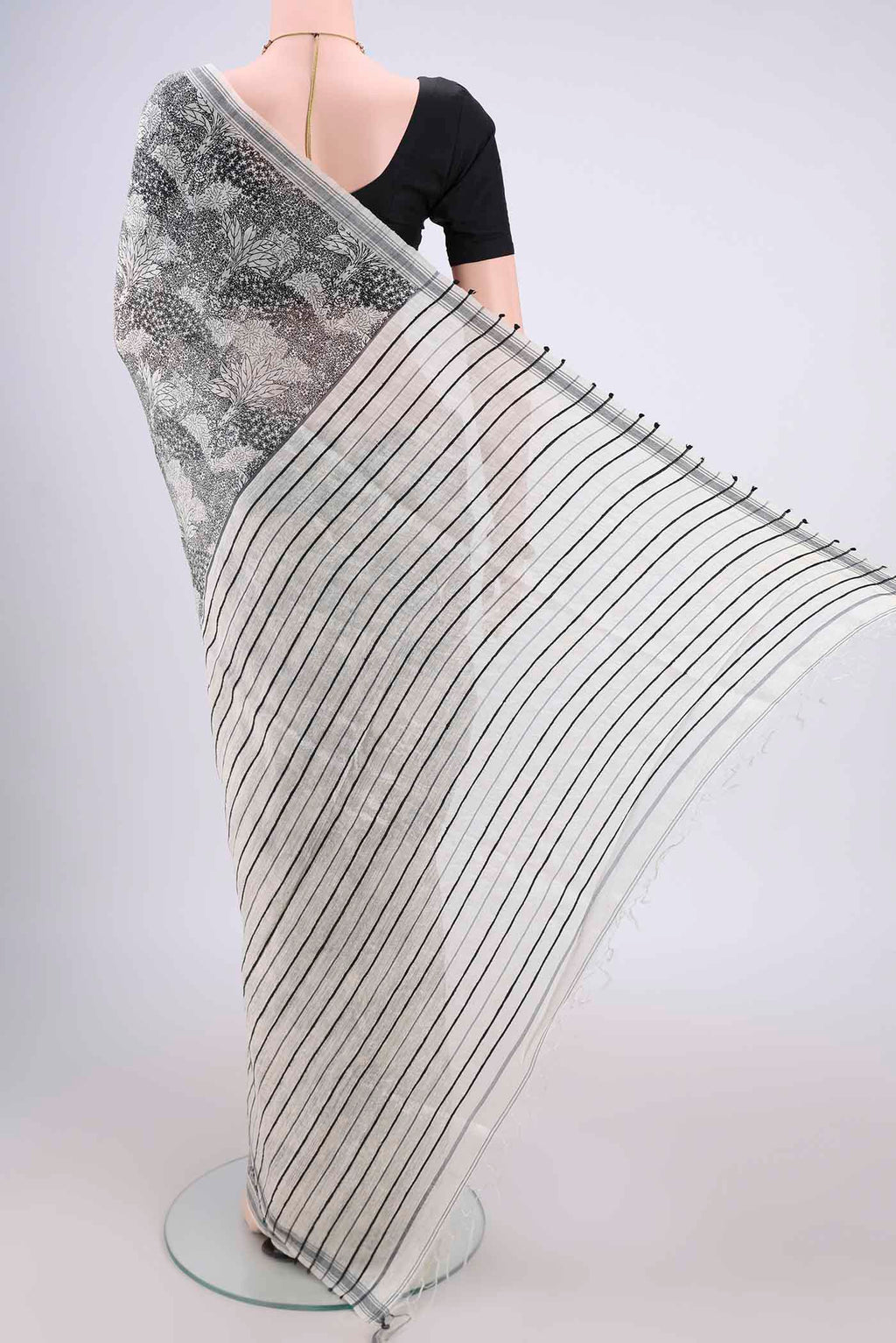 Flat view of Off White Tussar Silk Saree with Printed design on the body and Plain Border. 