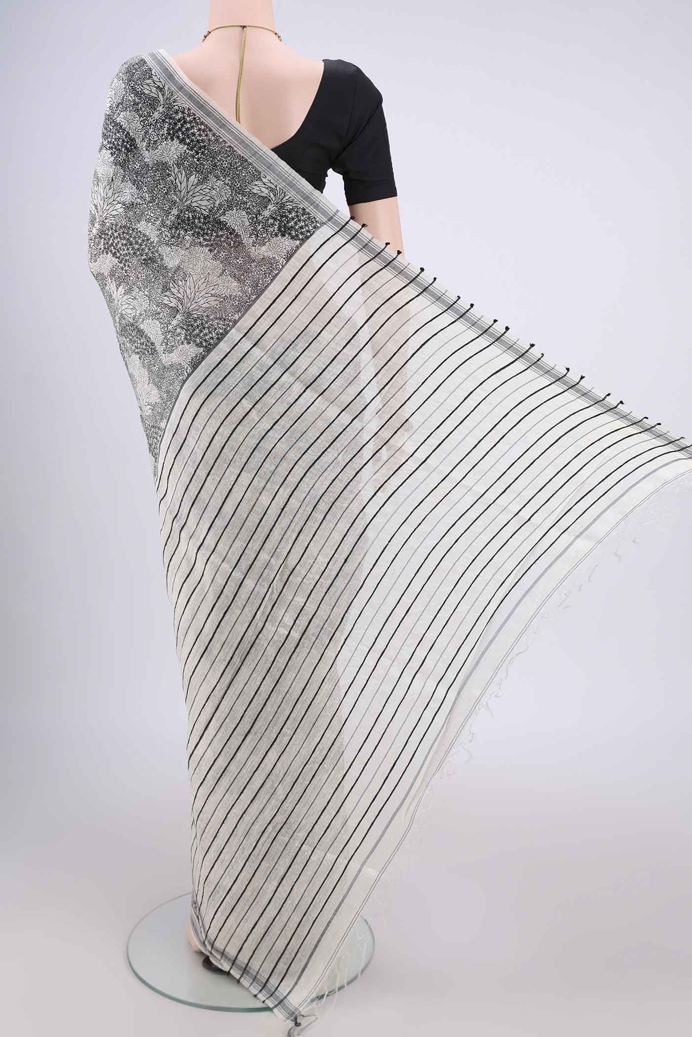 Flat view of Off White Tussar Silk Saree with Printed design on the body and Plain Border. 