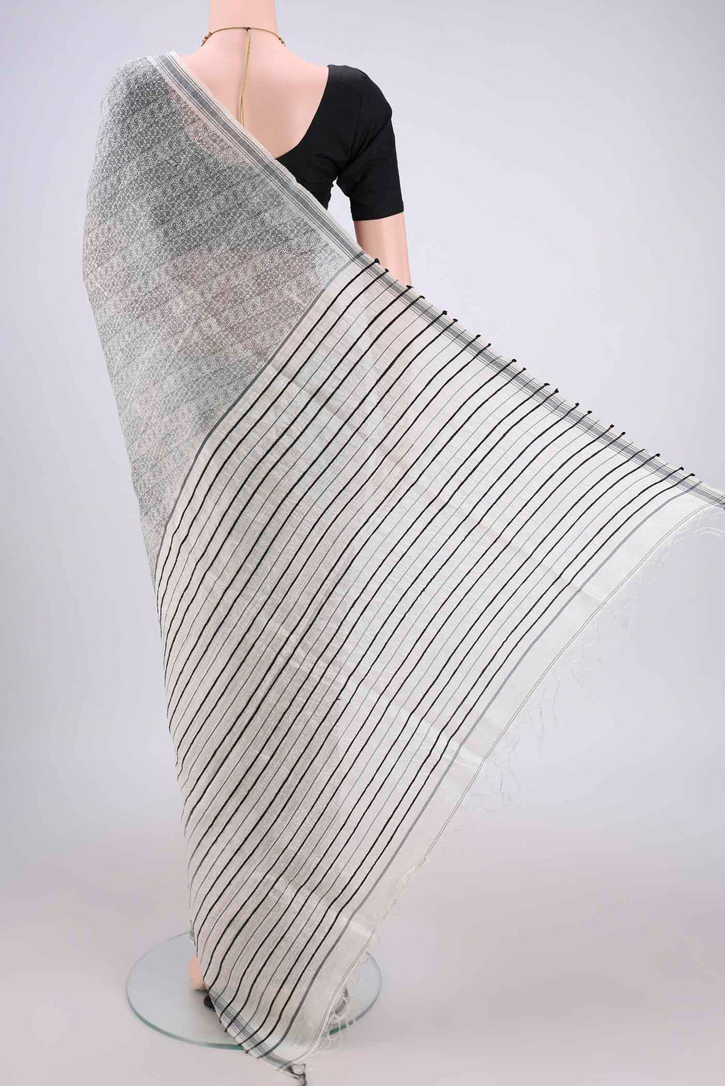 Flat view of Off White Tussar Silk Saree with Printed design on the body and Plain Border. 