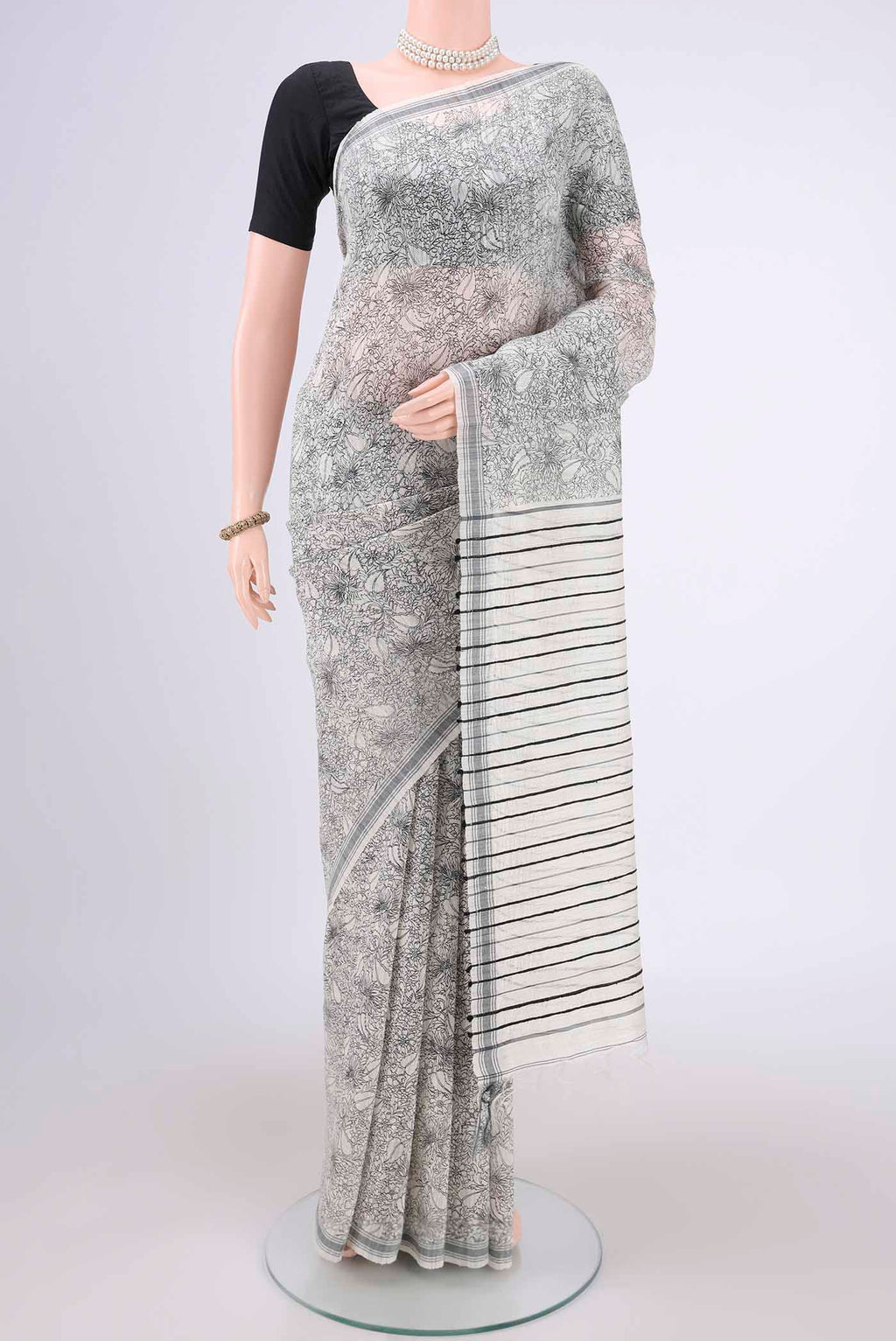 Off White Tussar Silk Saree with Printed design on the body and Plain Border.  displayed on a mannequin