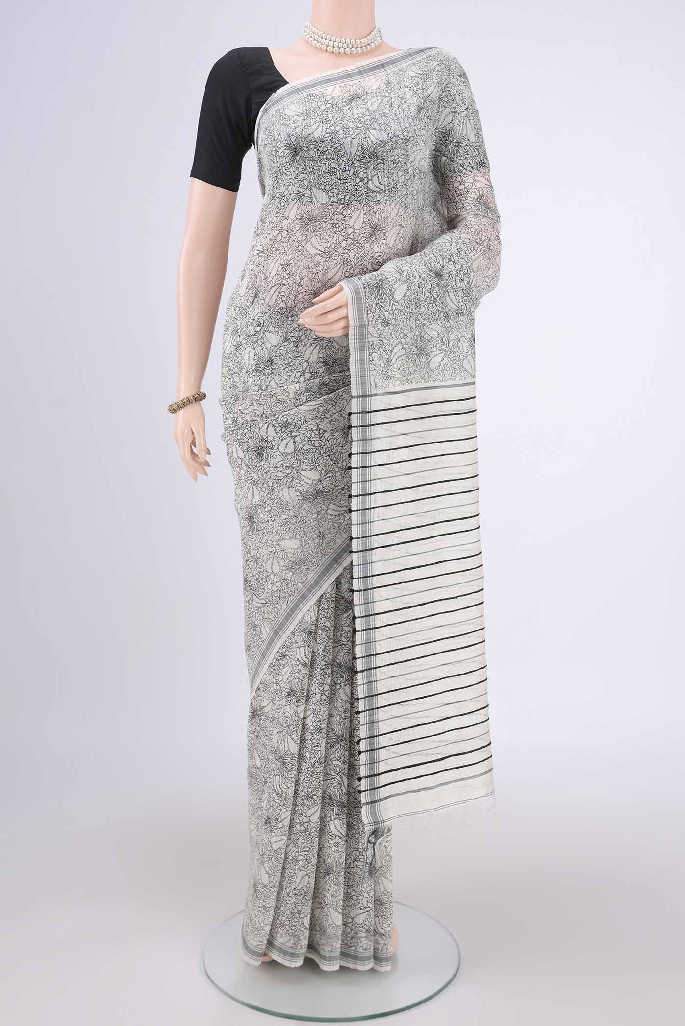 Off White Tussar Silk Saree with Printed design on the body and Plain Border.  displayed on a mannequin