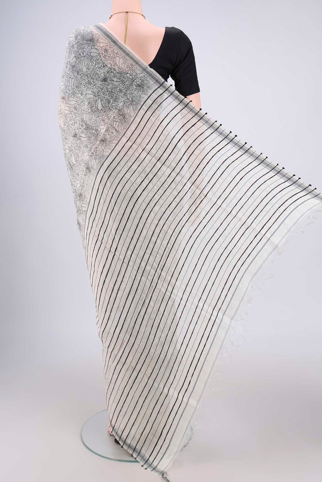 Flat view of Off White Tussar Silk Saree with Printed design on the body and Plain Border. 
