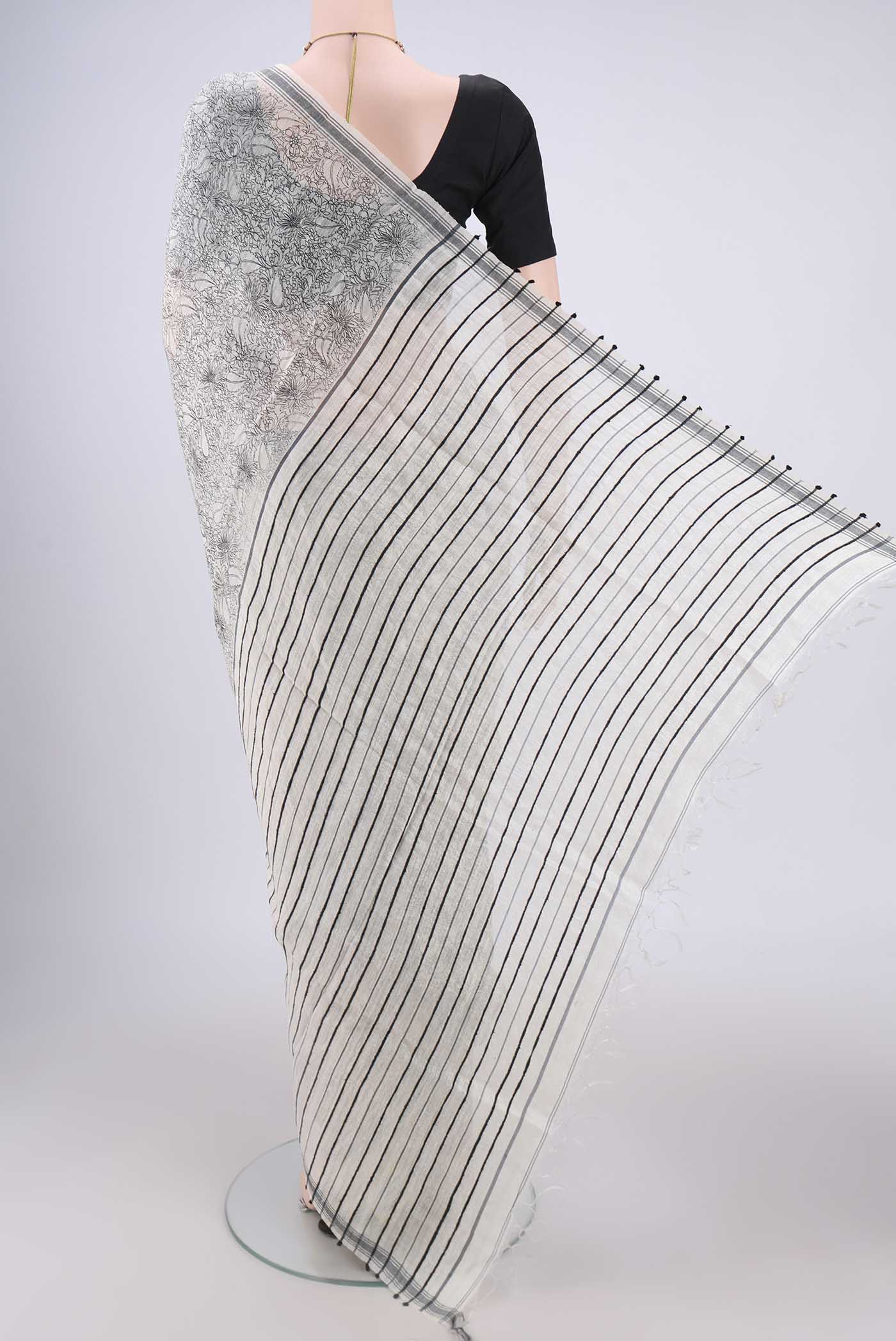 Flat view of Off White Tussar Silk Saree with Printed design on the body and Plain Border. 