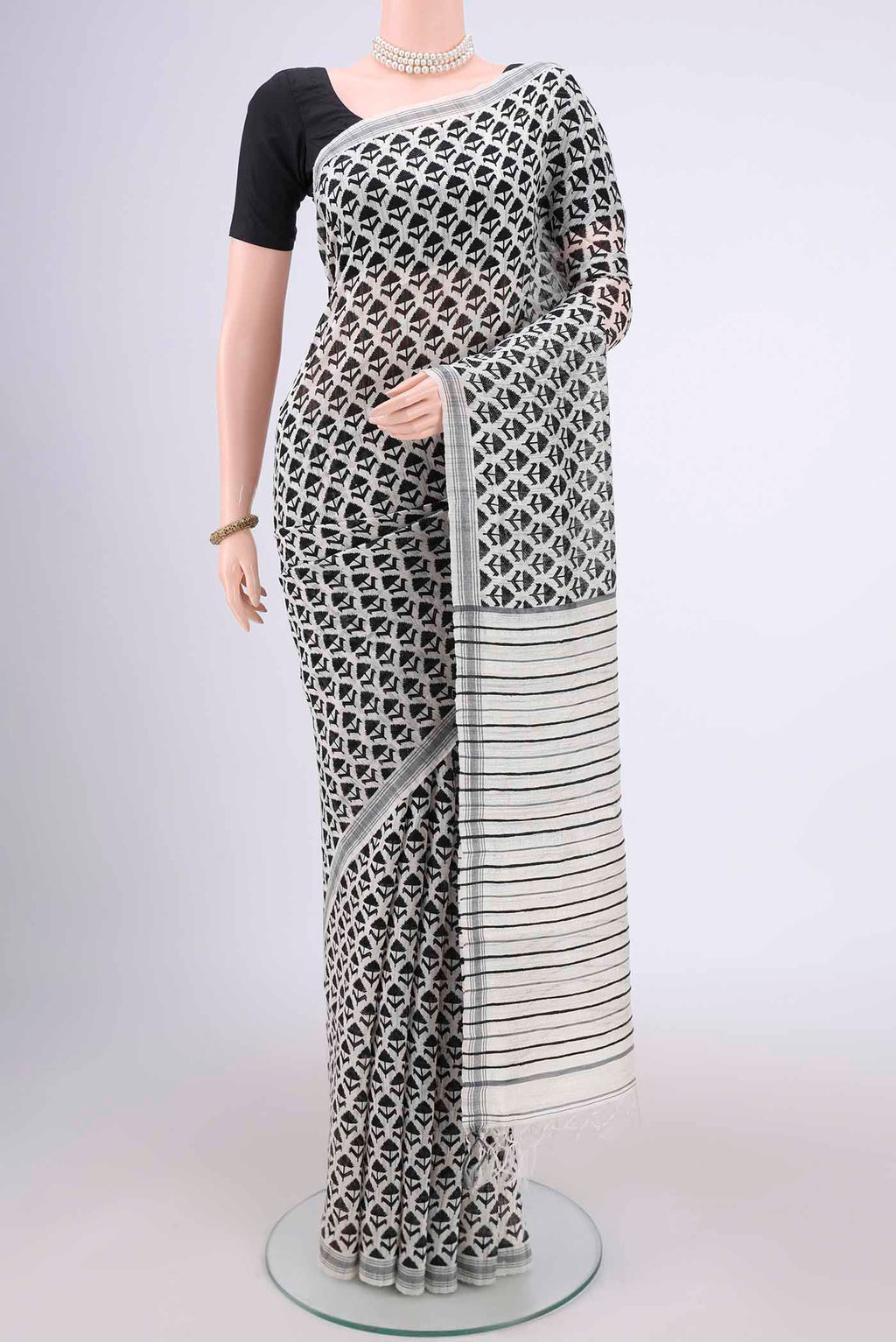 Off White Tussar Silk Saree with Printed design on the body and Plain Border.  displayed on a mannequin