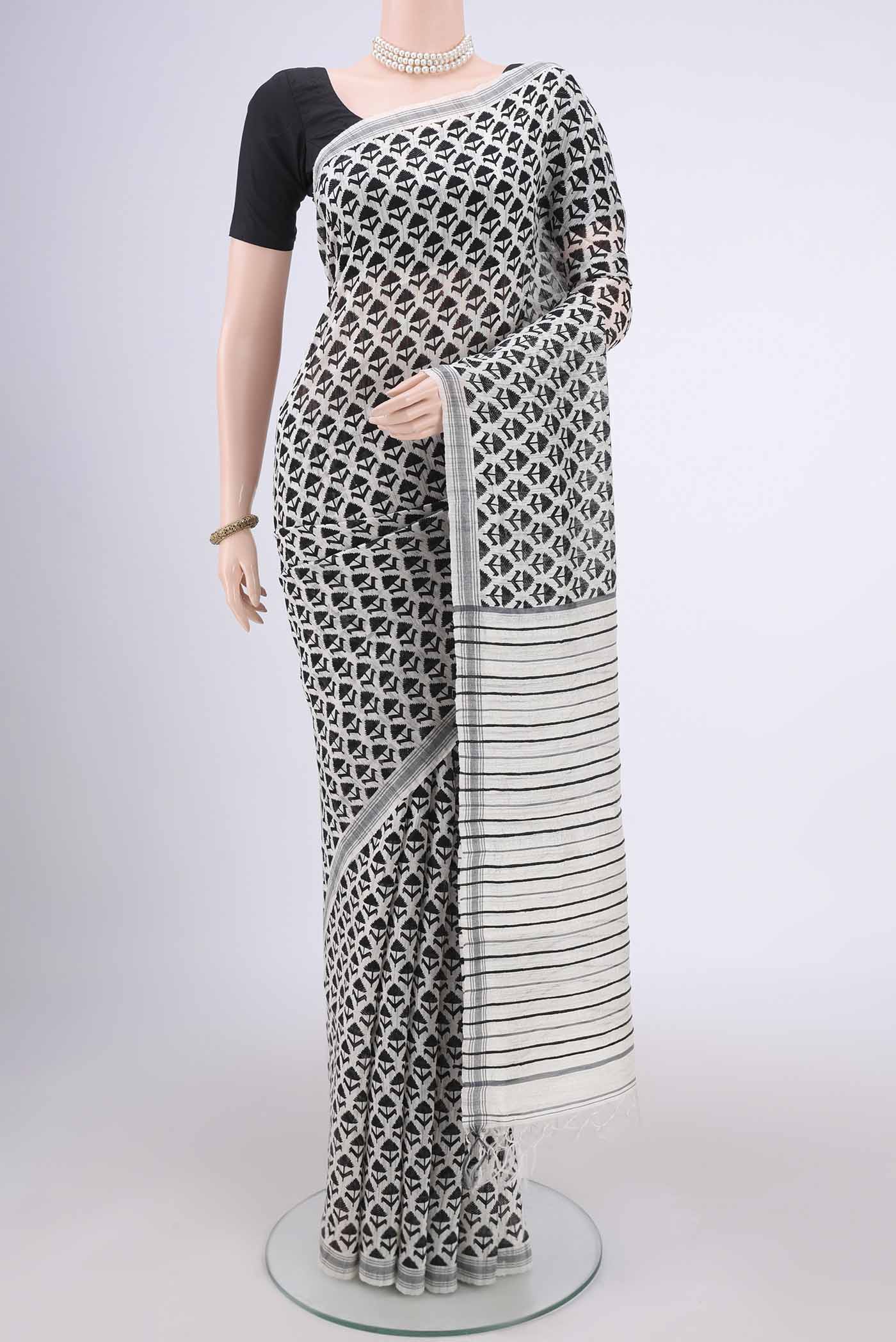 Off White Tussar Silk Saree with Printed design on the body and Plain Border.  displayed on a mannequin