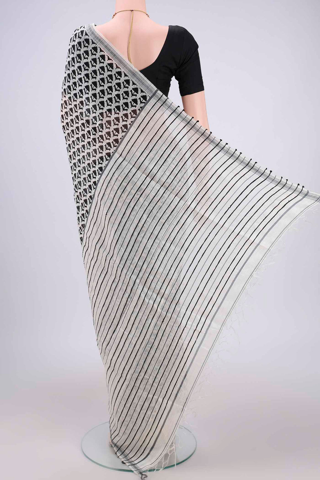 Flat view of Off White Tussar Silk Saree with Printed design on the body and Plain Border. 