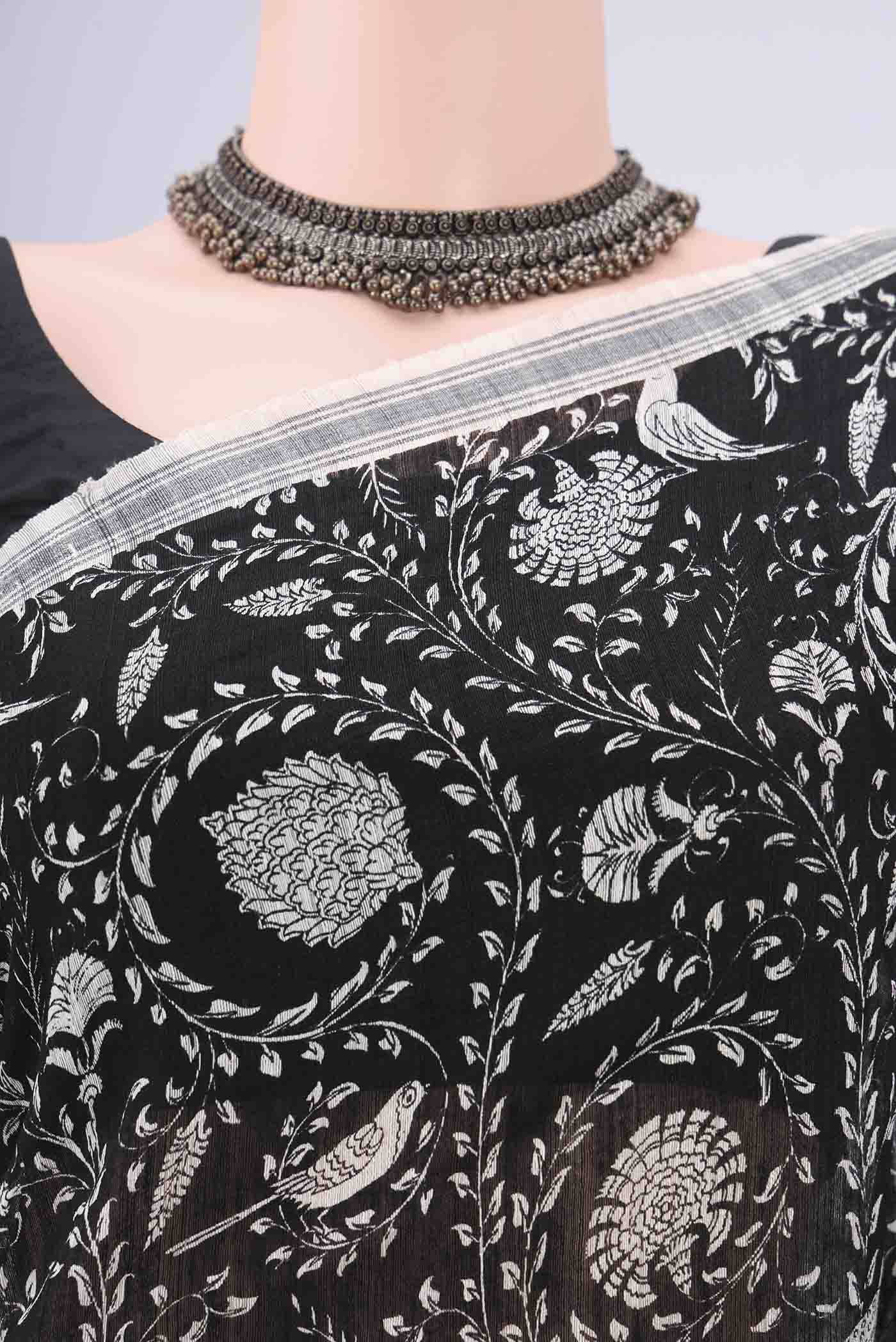 Border image of Black Tussar Silk Saree with Bird Print on the body and Plain Border. 