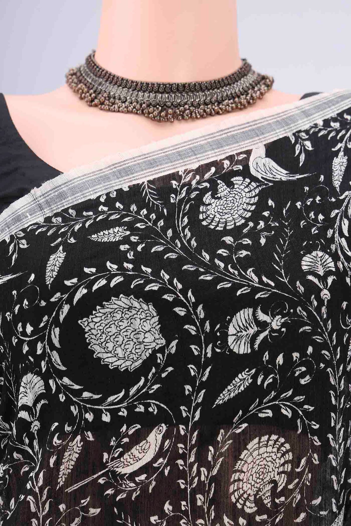 Border image of Black Tussar Silk Saree with Bird Print on the body and Plain Border. 