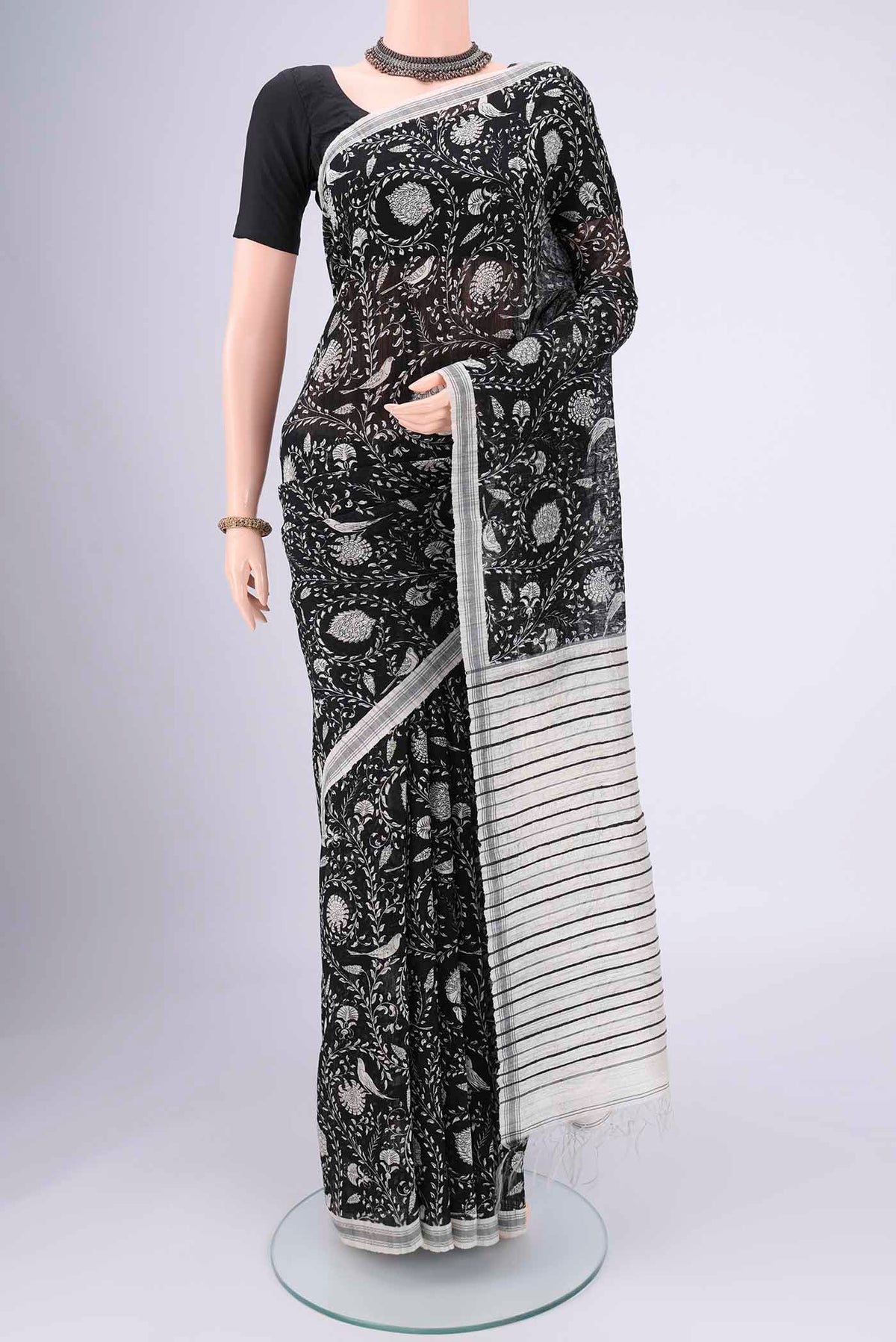 Black Tussar Silk Saree with Bird Print on the body and Plain Border.  displayed on a mannequin