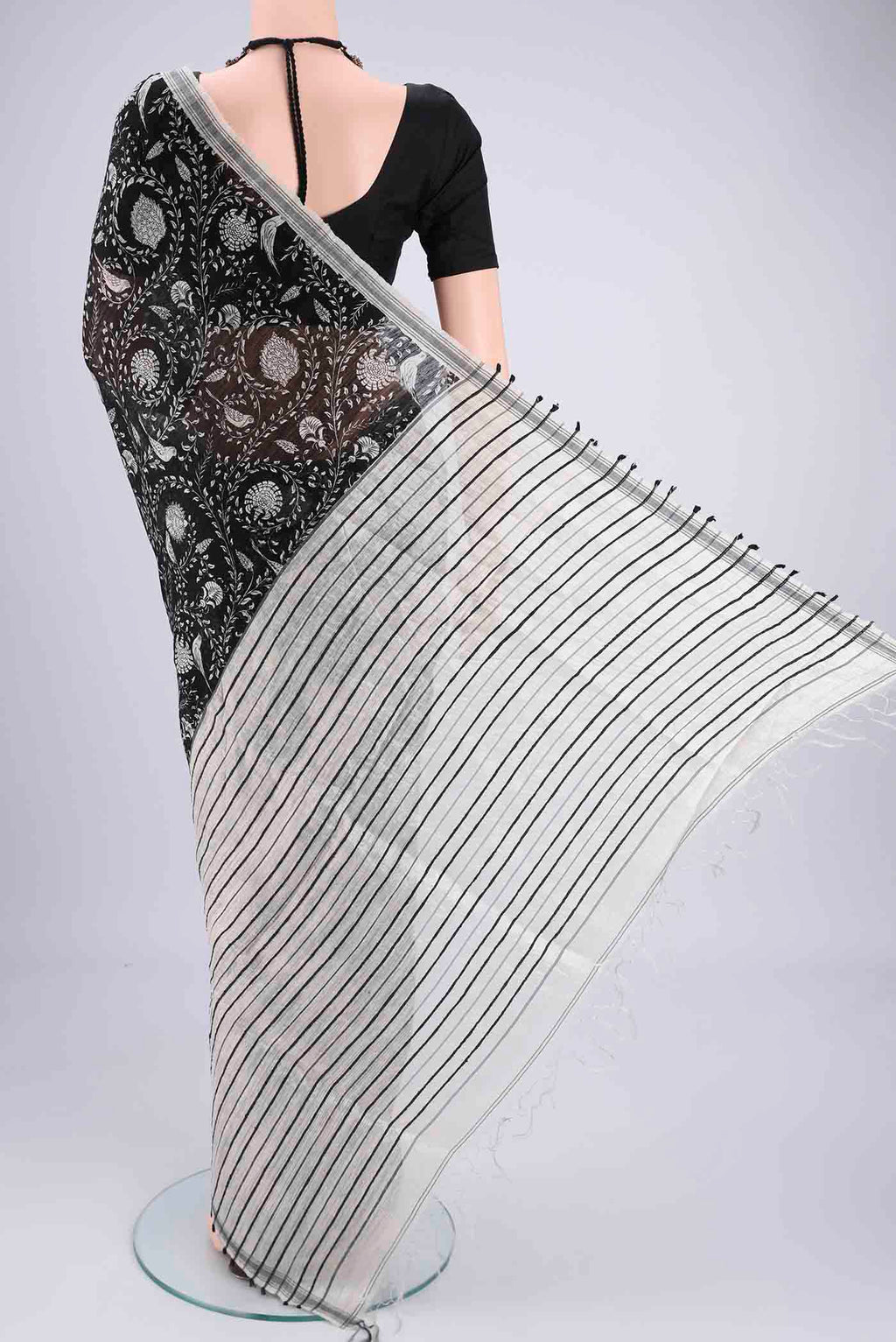 Flat view of Black Tussar Silk Saree with Bird Print on the body and Plain Border. 