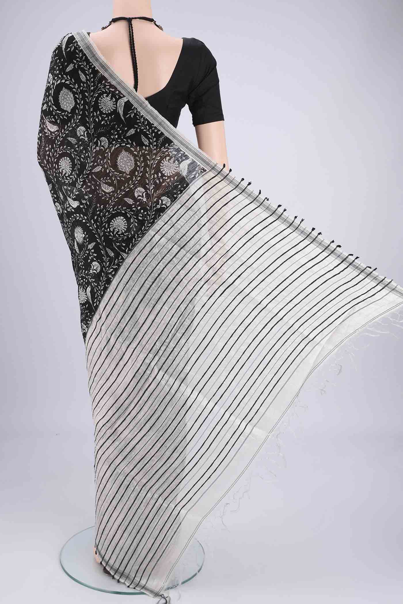 Flat view of Black Tussar Silk Saree with Bird Print on the body and Plain Border. 